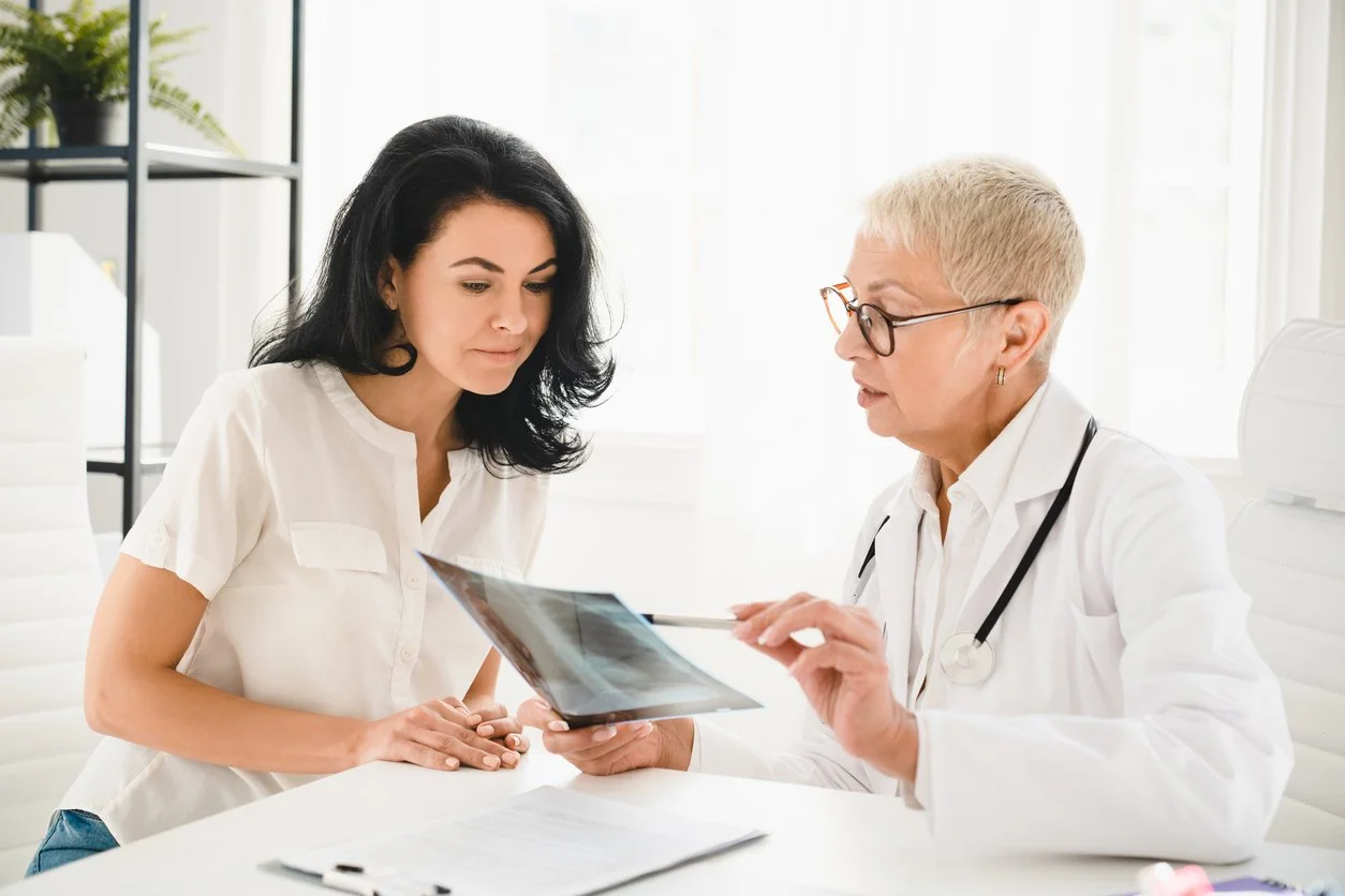 Midlife woman in perimenopause discussing bone health and hormone therapy with her physician