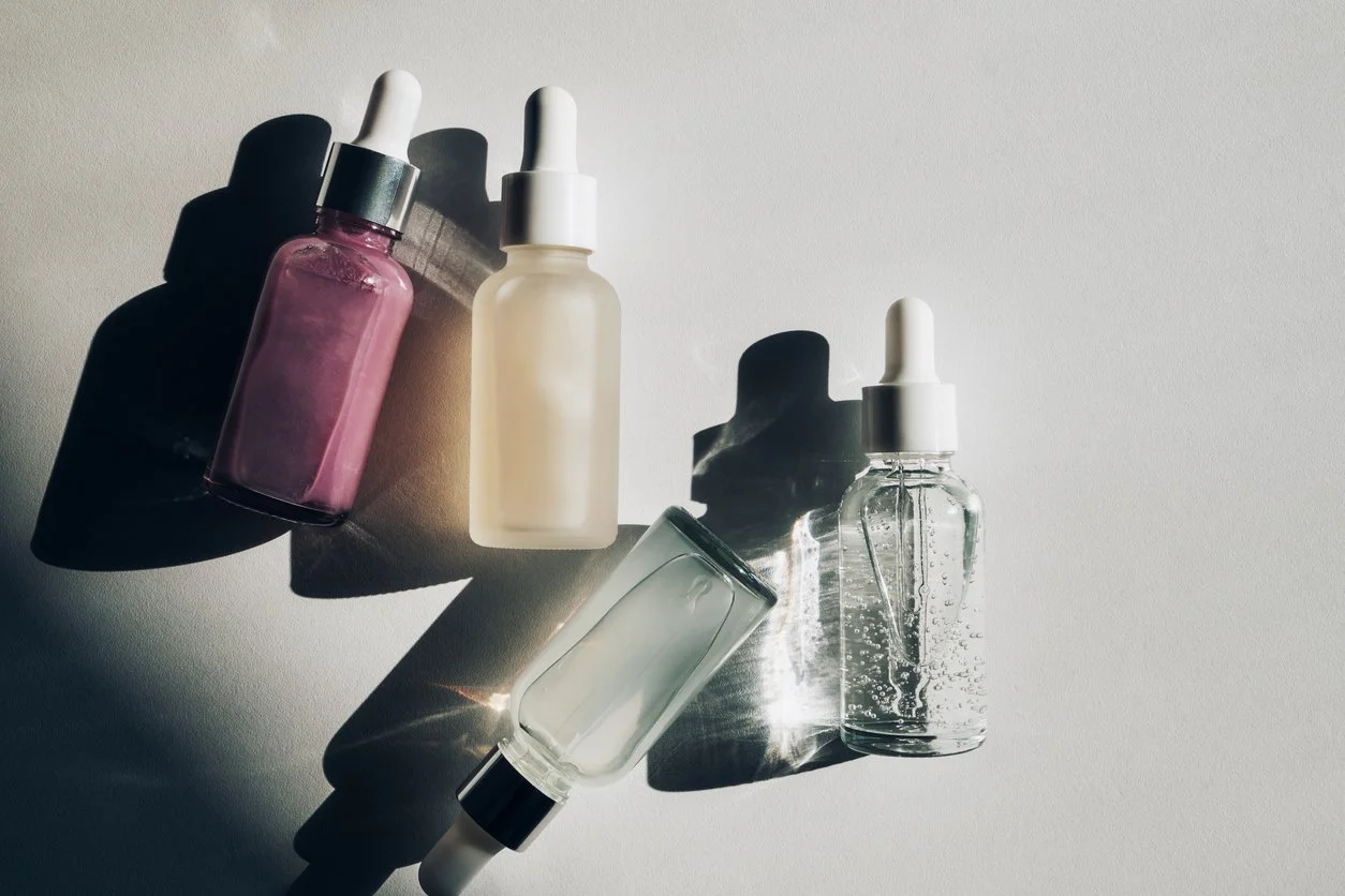 Four different skincare product bottles