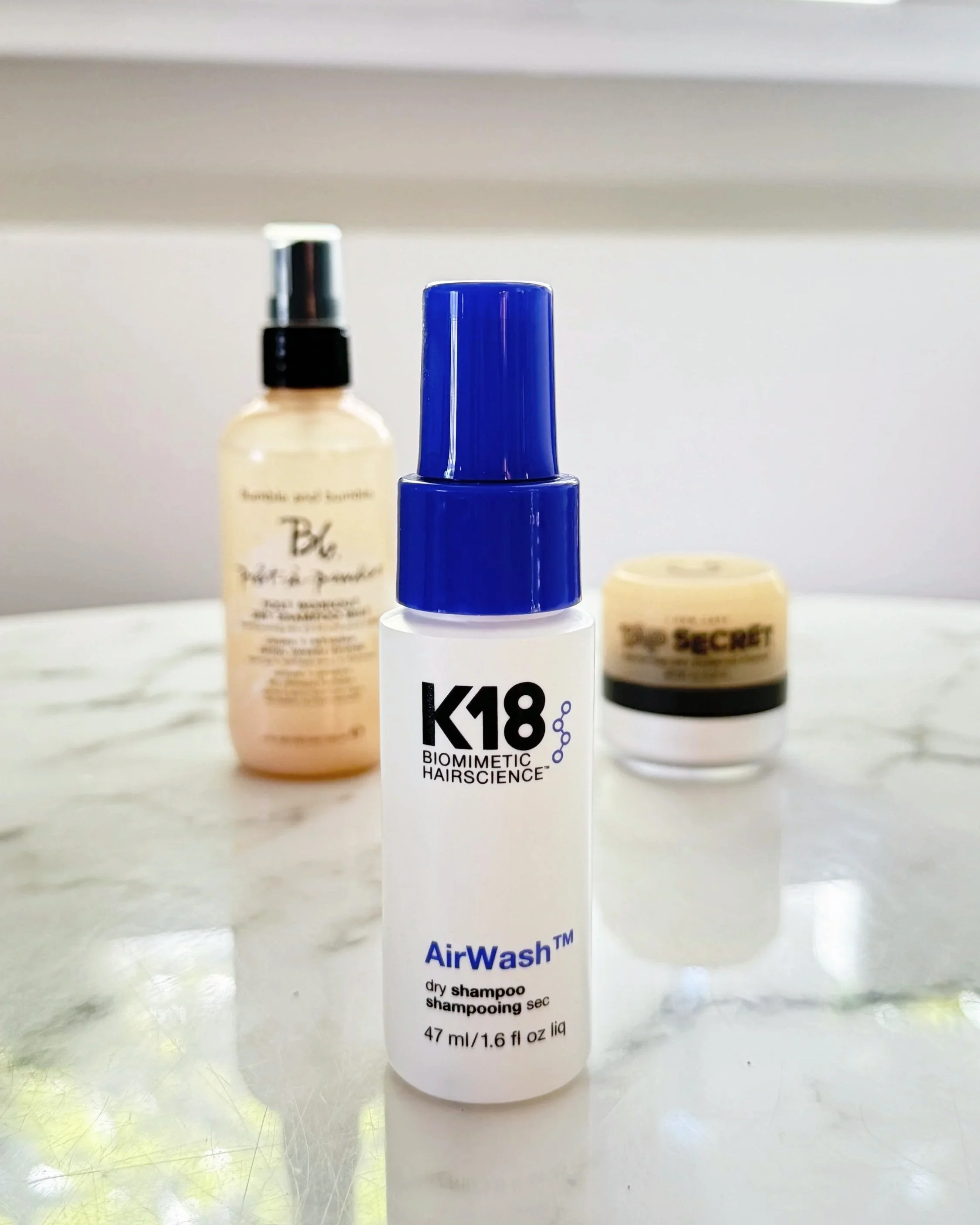 K18 AirWash Dry Shampoo in front of Bumble and bumble pret-a-powder post workout dry shampoo mist and tap secret dry shampoo