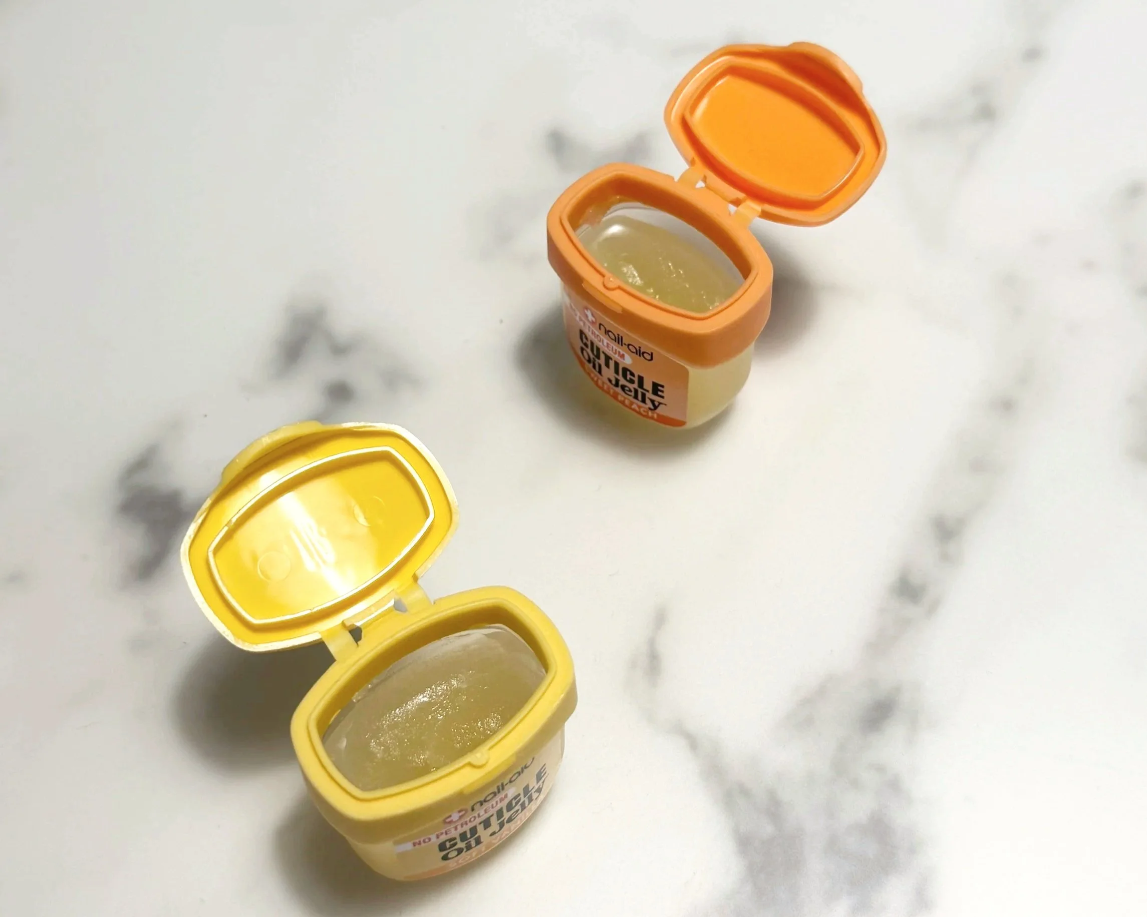 Two pots of Nail-Aid Cuticle Jelly, opened