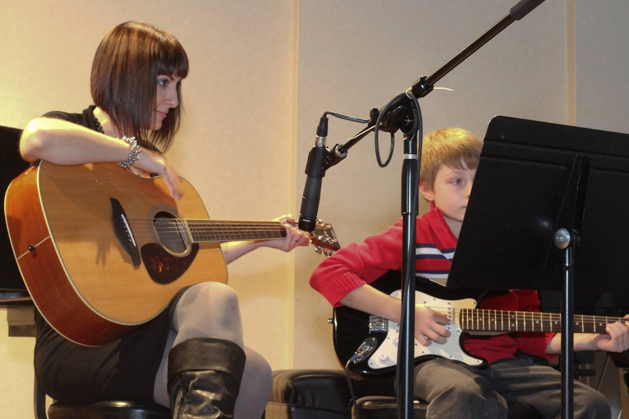 Ms. Brown accompanying a student on guitar at his first concert 