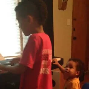 Ms. Brown's boys practicing at home during their younger years. Damien practices for a performance while Noah assists him in singing "See You Again".