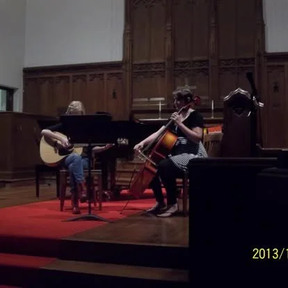 Ms. Brown accompanying a guitar and vocal student on cello and back up vocals for an event located at our former teaching spaces In university City