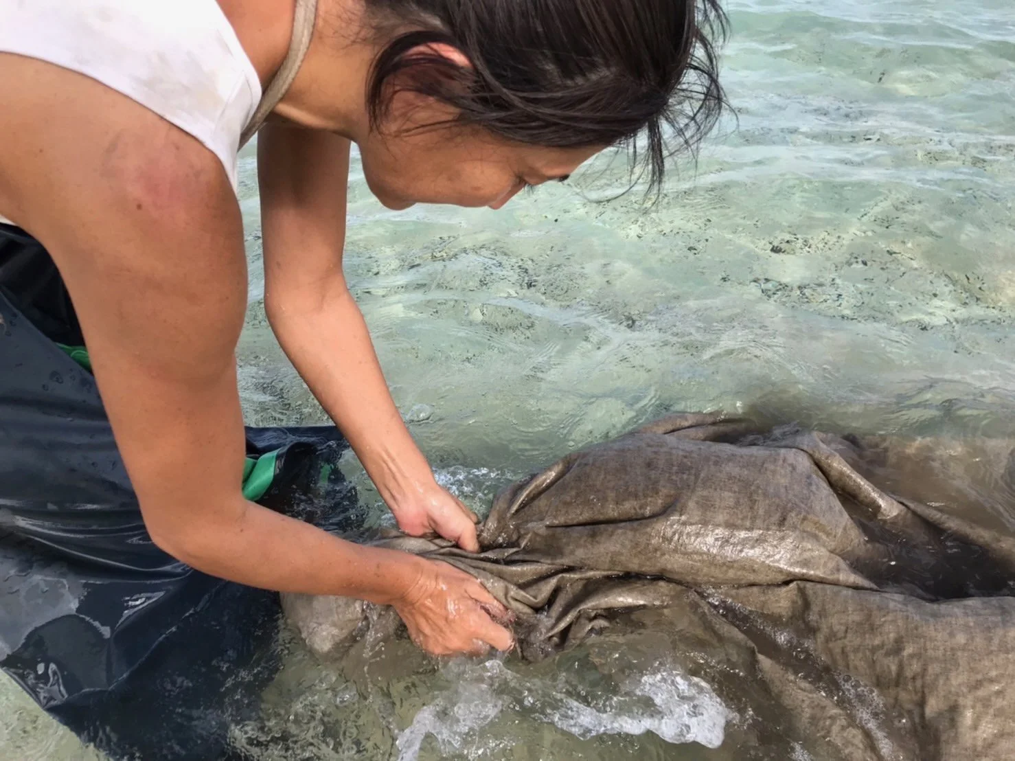 Hemp — ocean-rinse.

The final step: cloth is rinsed in the ocean to wash away excess mud and reveal the finished tone. This process — plant-dye, mud-wash, ocean-rinse — gives the textile a depth and quiet complexity that continues to shift over time