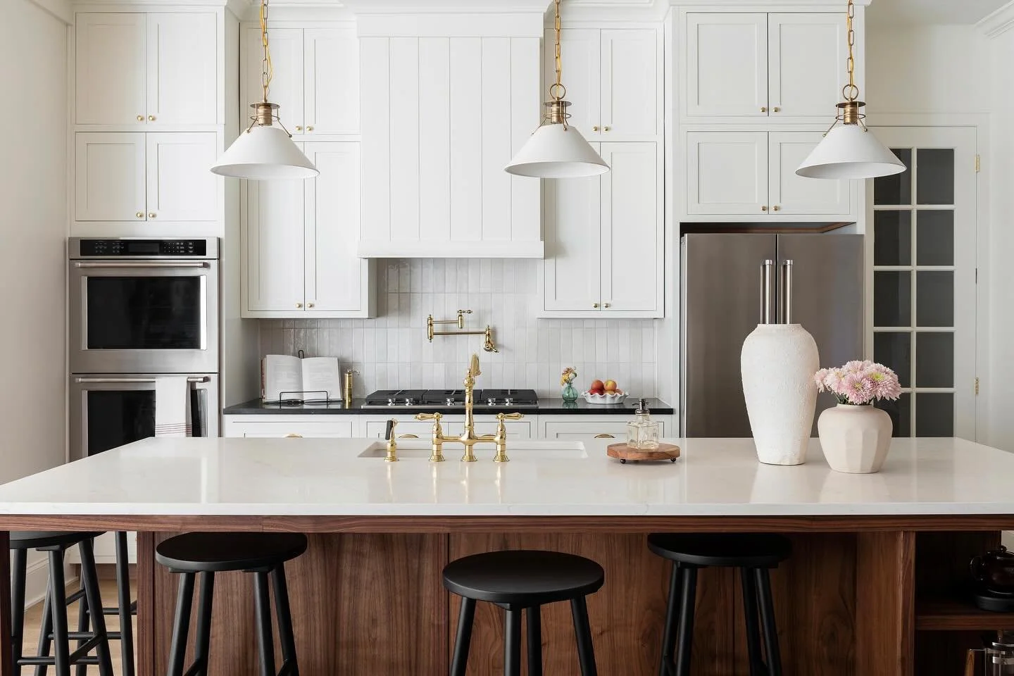 This English inspired kitchen is the heart of the home (literally!) at New Hope, with its creamy walls, unlacquered brass metal finishes, and a warm walnut island built in. I see many memories made around this island, and let&rsquo;s be honest, a few