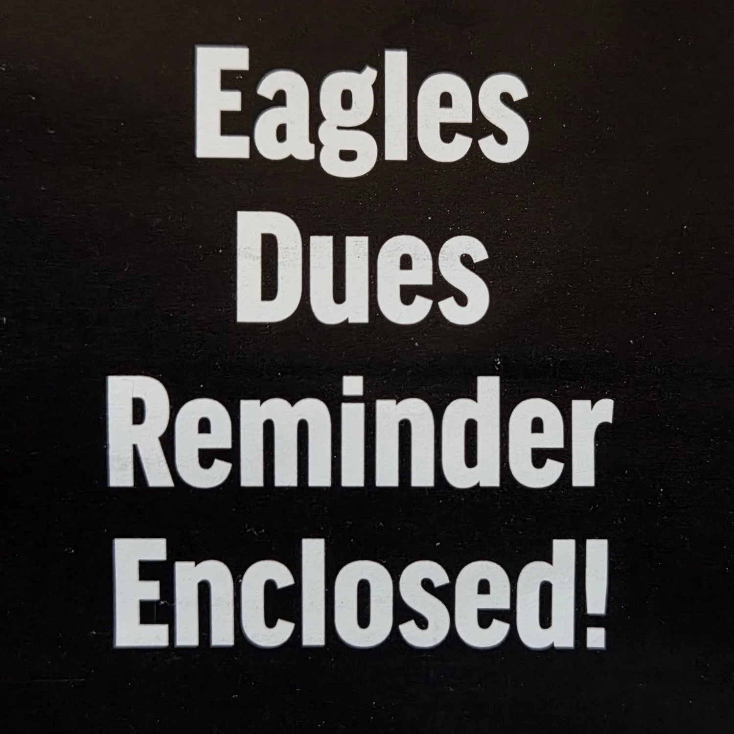 White letters on black square say "Eagles Dues Reminder Enclosed!"