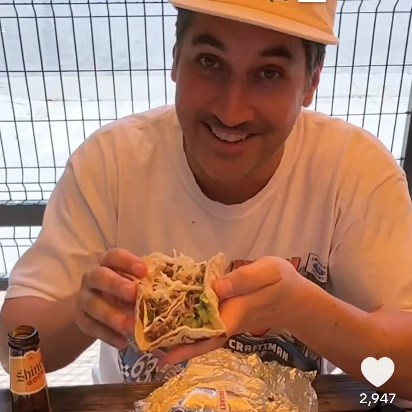 Image from Tiktok of comedian Carmen Christopher holding a taco he's about to eat.