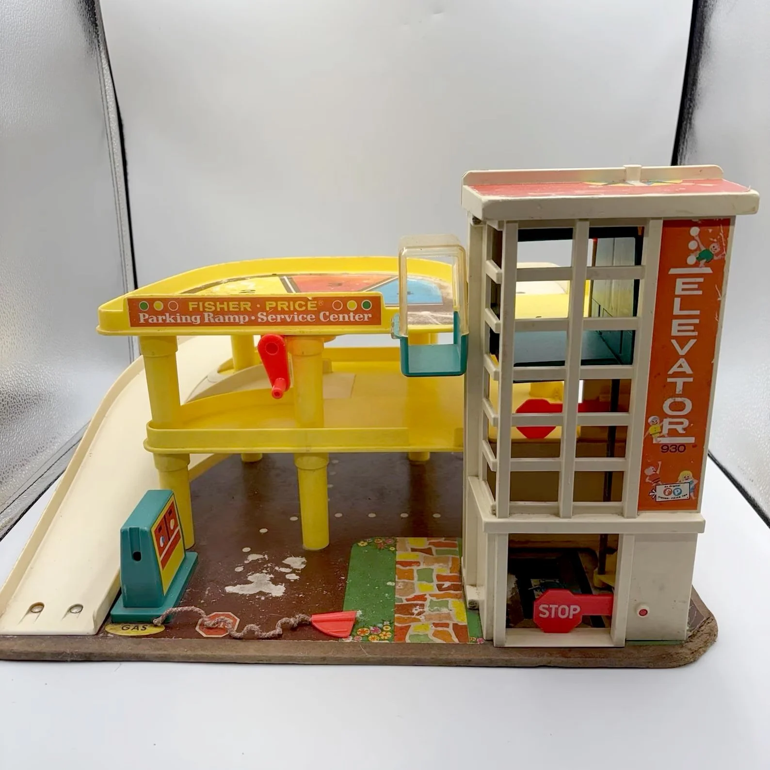 Photo of a 1970s era Fisher Price toy  parking garage with a car elevator
