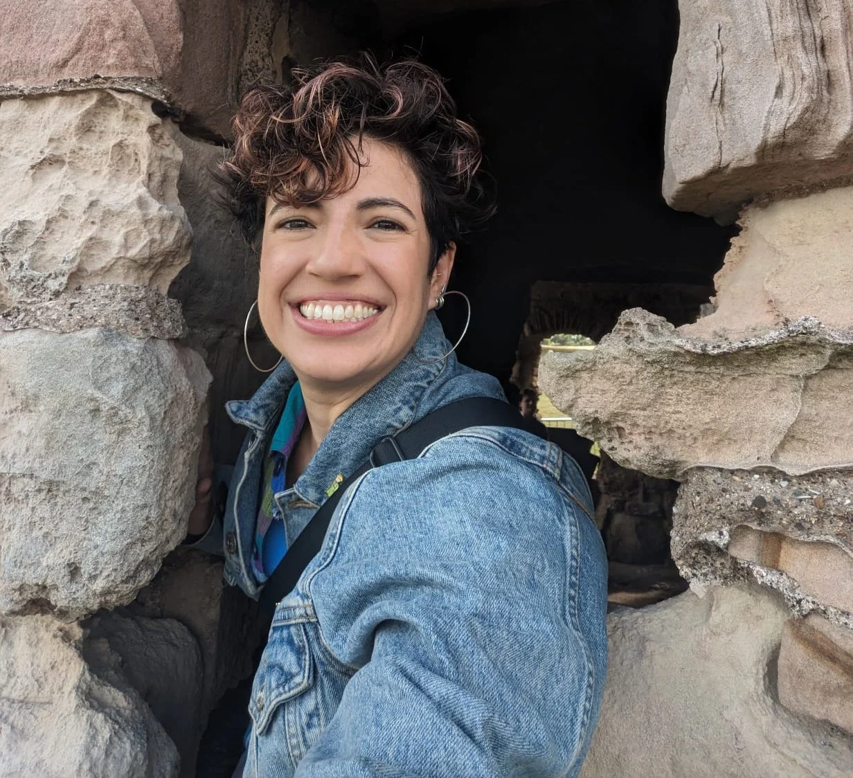 A selfie of listener Avalon Hernandez. who has large hoop earrings and a jean jacket.