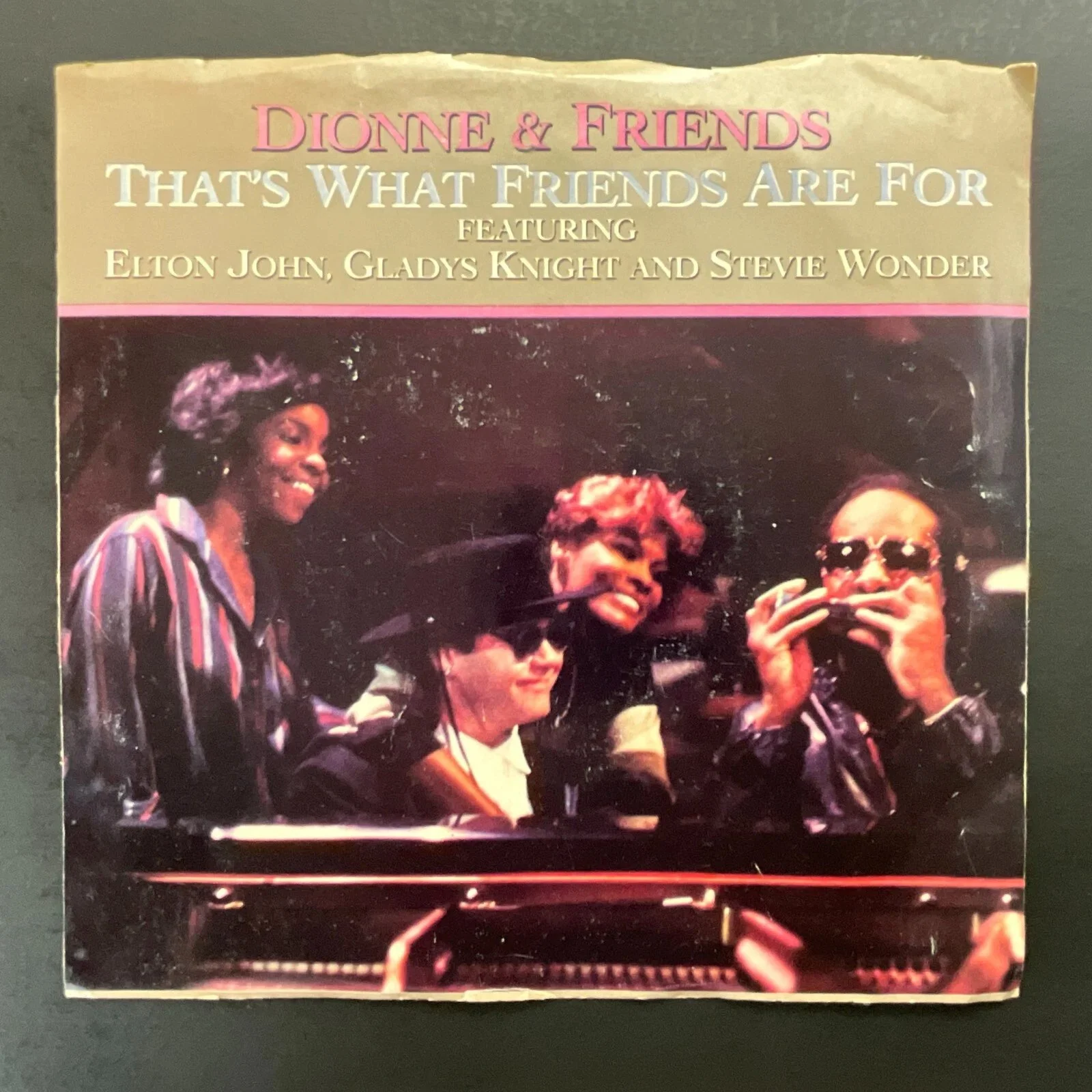 Photo of a somewhat wrinkle record sleeve for "Dionne & Friends" "That's What Friends Are For" 45 rpm album showing Dionne Warwick, Stevie Wonder, Elton Jon, Gladys Knight