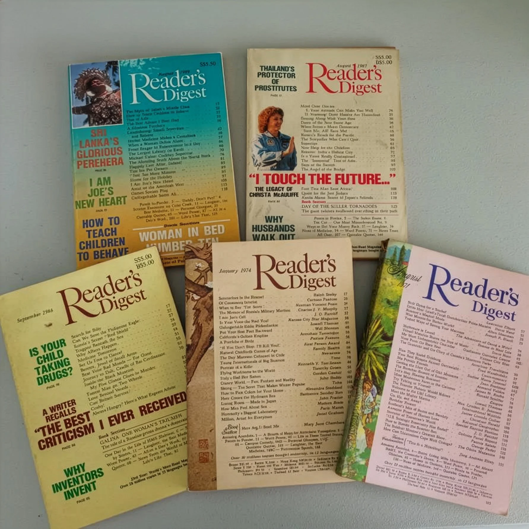 Photo of 5 vintage Reader's Digests spread out on a table