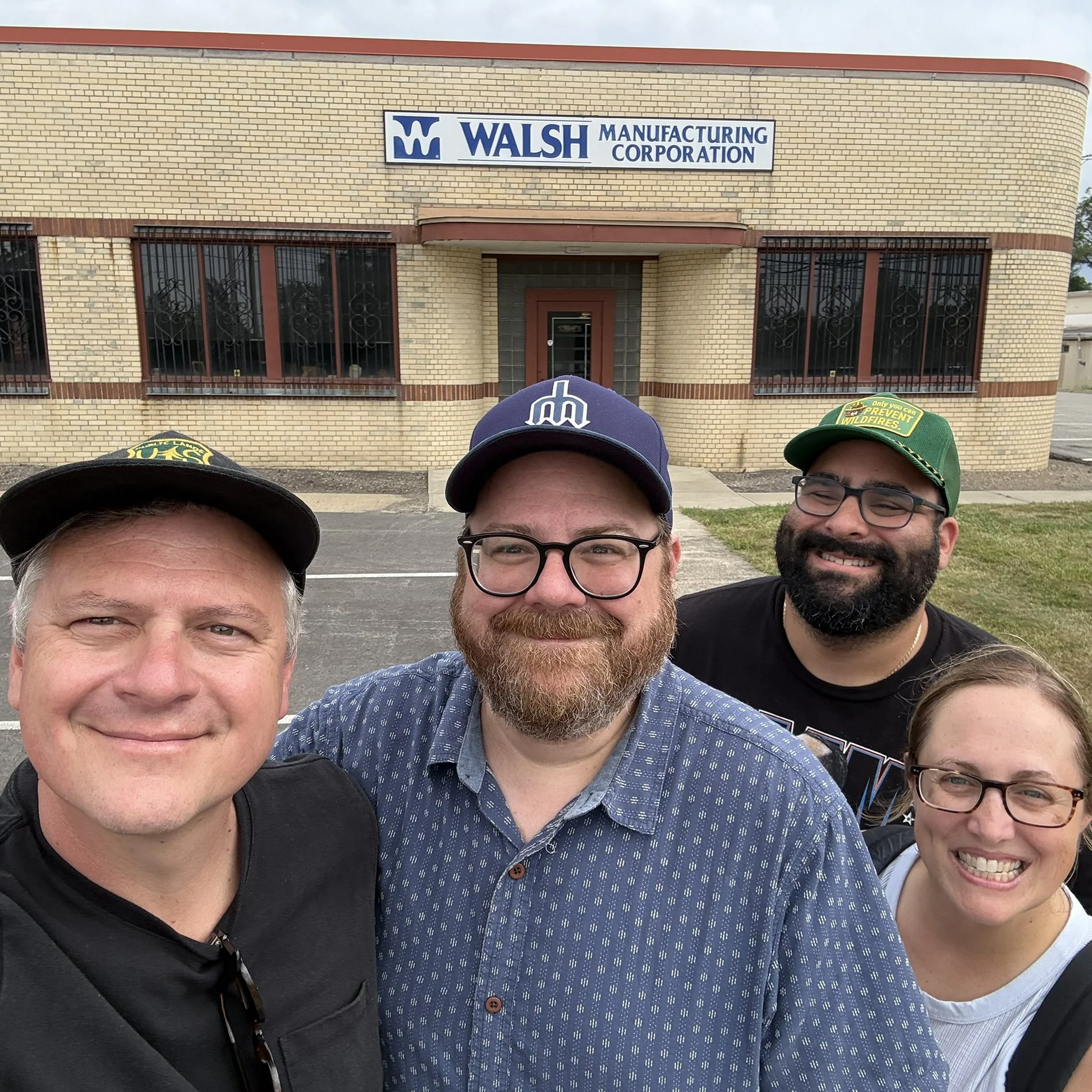 Photo of Luke, Andrew, Jon and Jessica standing outside the Walsh Manufacturing building in Cleveland