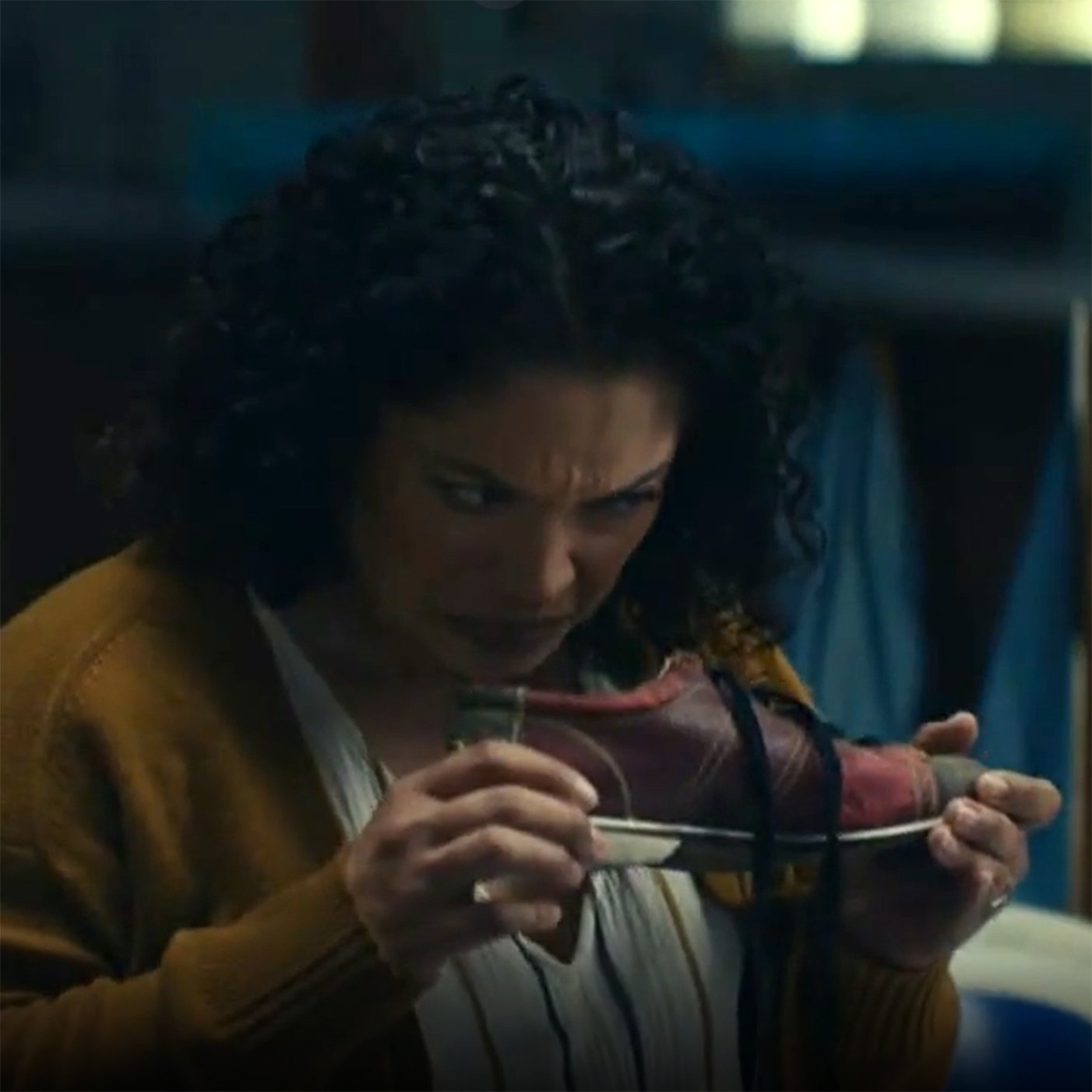 Screenshot from a TV commercial showing a middle-aged lady smelling a bowling shoe