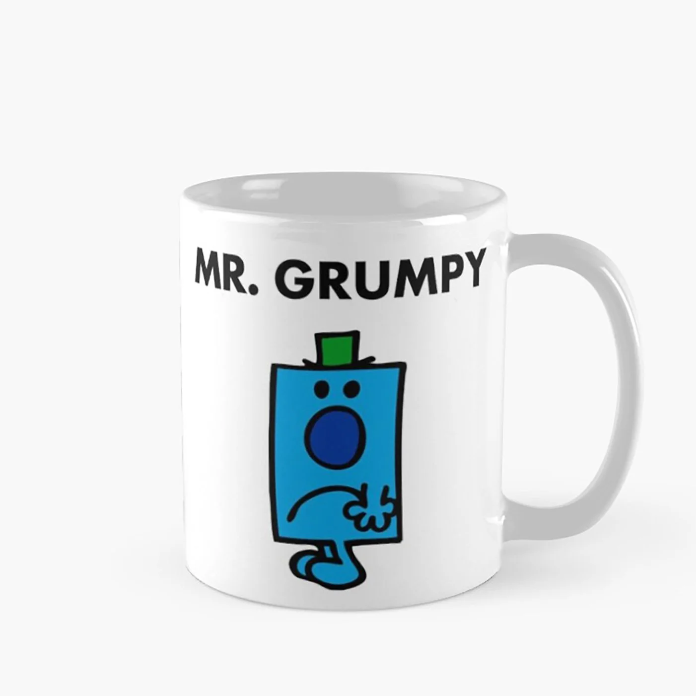 Stock photo of a white mug with the character Mr. Grumpy from the 1970s-era children's book series called "Mr. Men." He's a simply-drawn blue square with arms and legs, a frown, and a tiny green top hat.