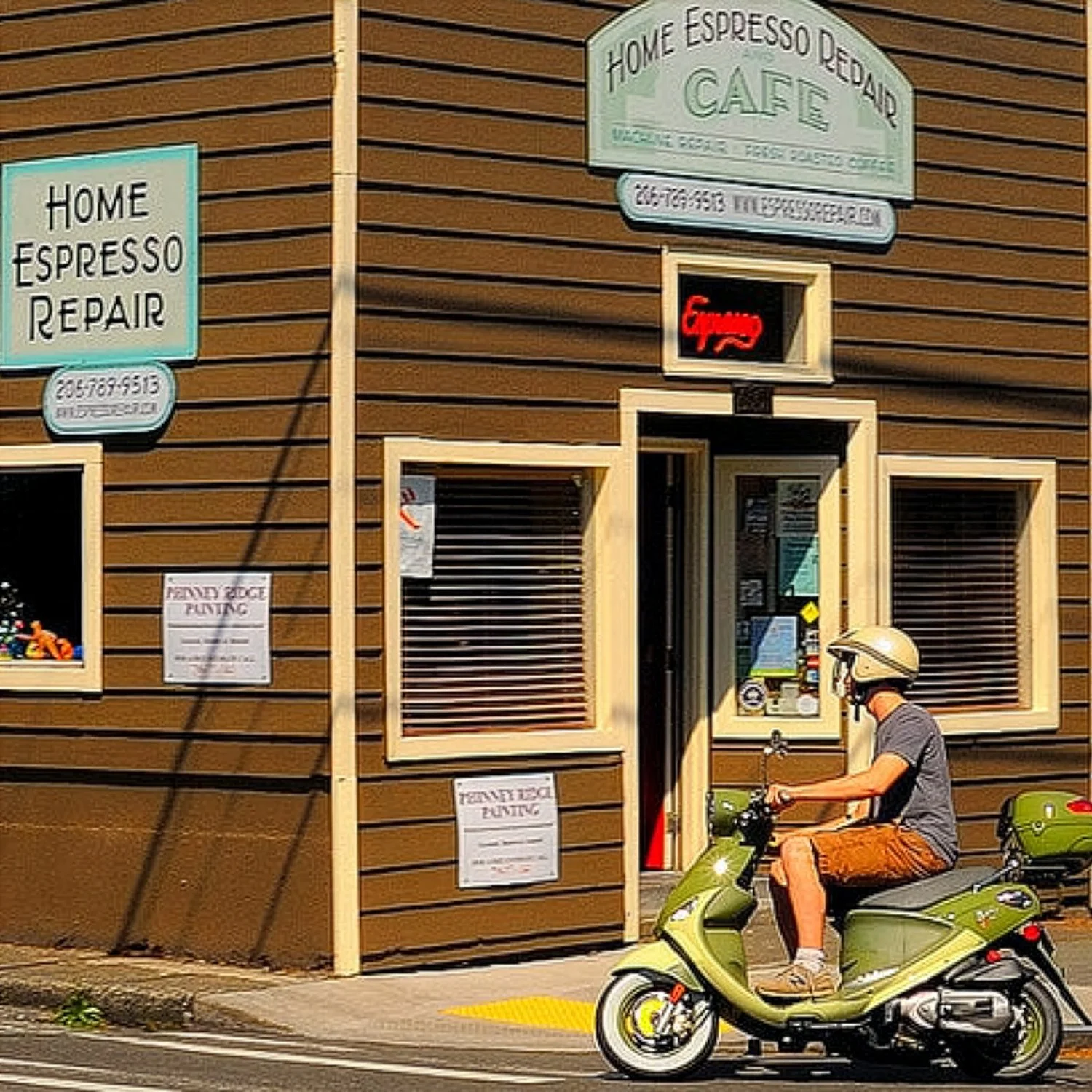 Photo of a man on a scooter driving by a small building with signs that says Home Espresso Repair