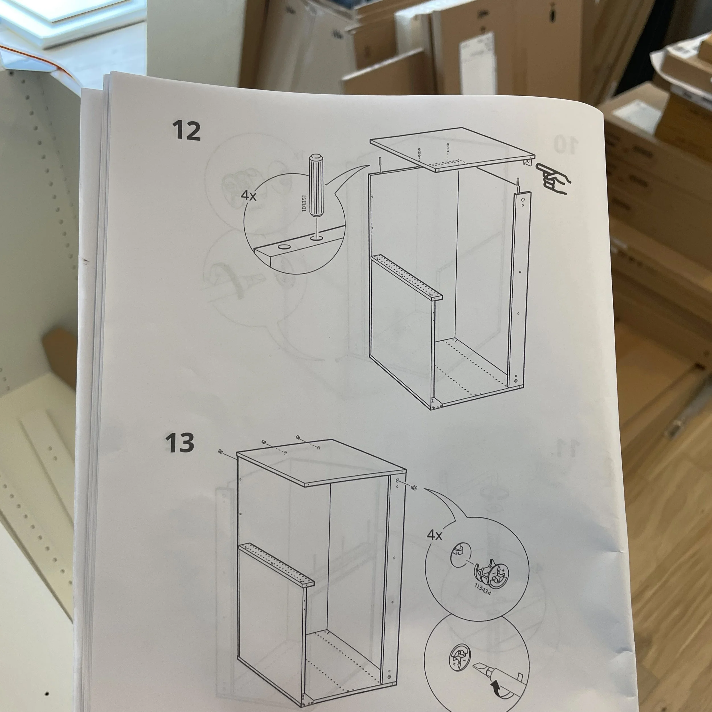 Photo of confusing IKEA instructions taken in a room full of boxes