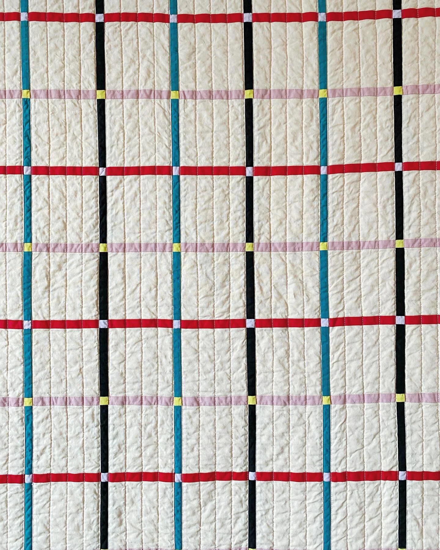 Grid quilt 

About 93&rdquo; square (236 cm)
Machine pieced and quilted, machine &amp; hand bound. 

Backing is pieced from two vintage striped cotton muslin sheets.

It was my first bed sized quilt (when I started it), and a lot of learning happened