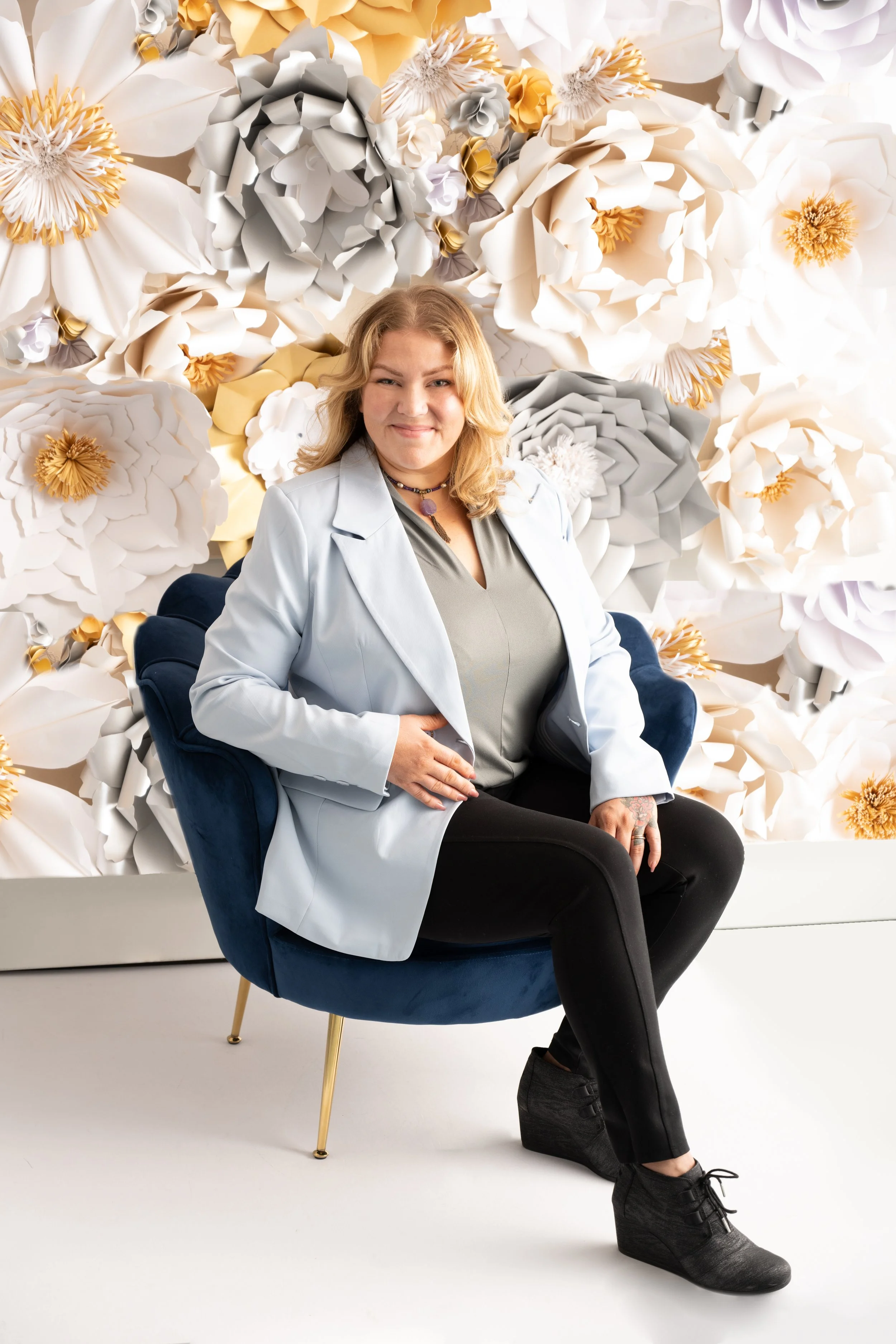 Anna wearing a blue blazer and black pants