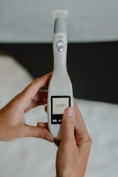 Holding a Jet Plasma wand before a Jet Plasma treatment in Buffalo at Anna Elizabeth Esthetics