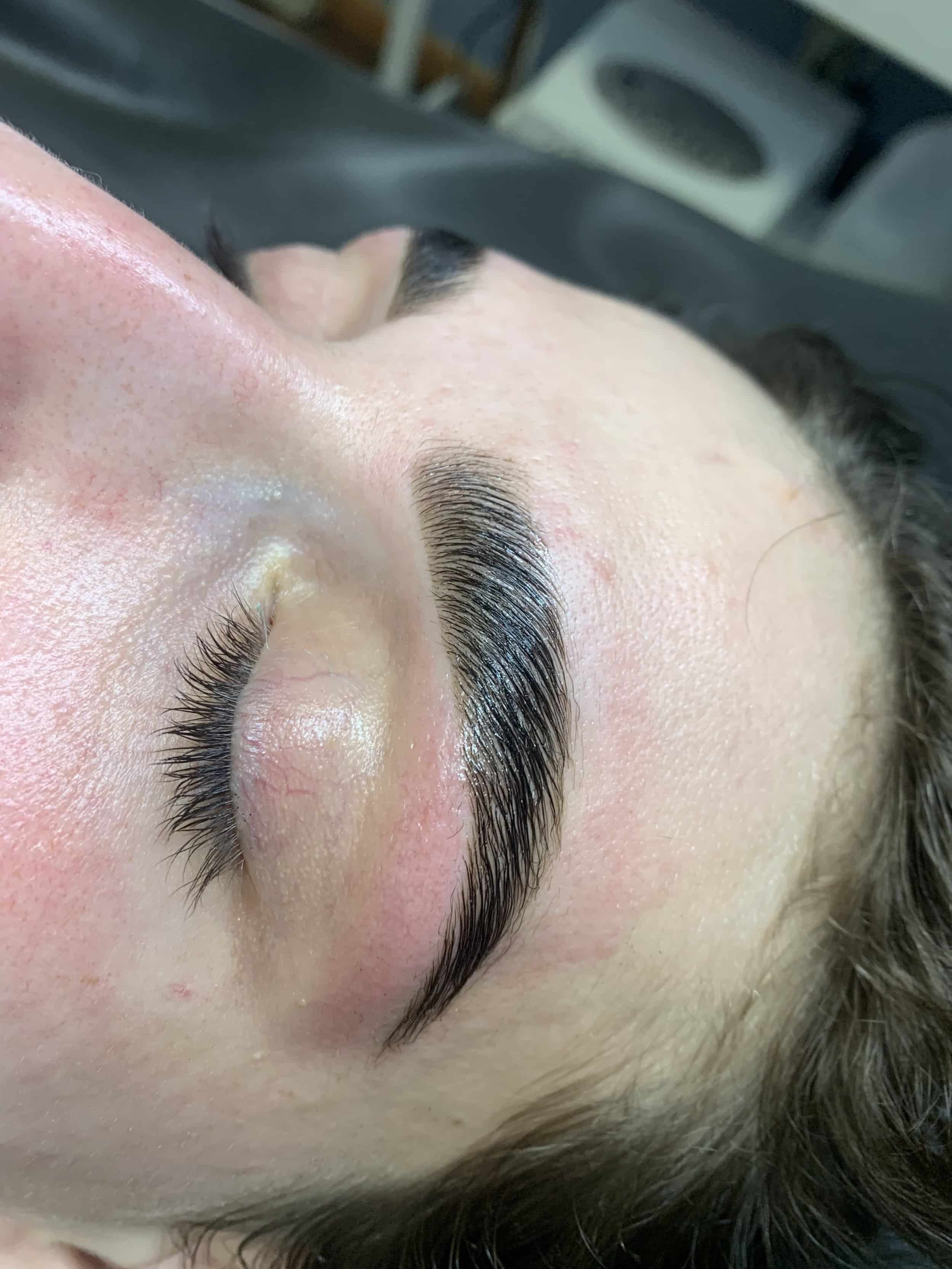 Female client with dark brown eyebrows after brow lamination