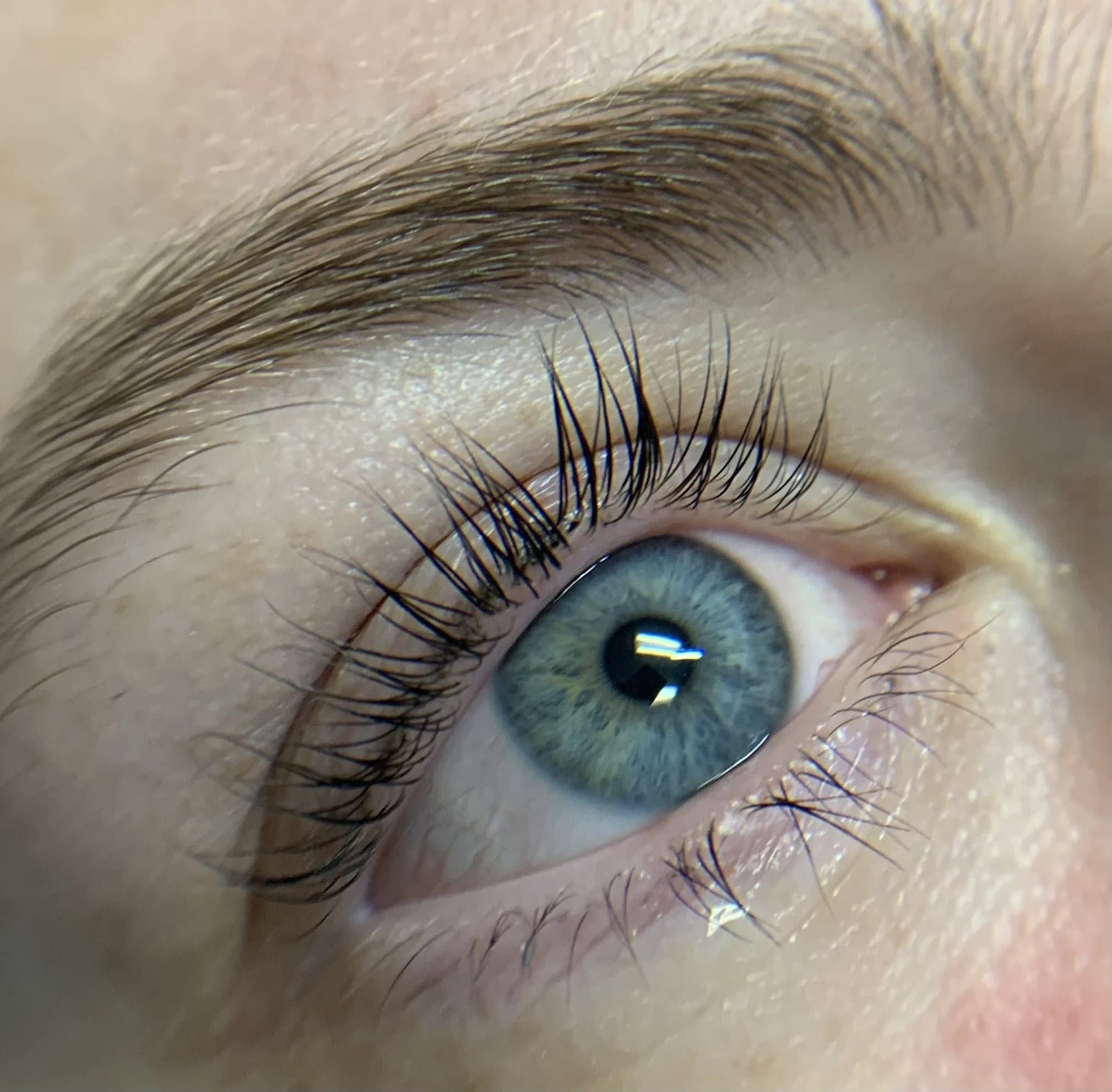 Female with blue eyes with long lashes after a lash lift