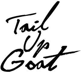 Handwritten text reading 'Tail Up Goat' in black ink on a white background.