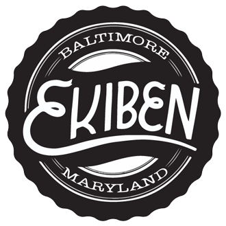 A circular black and white logo for Ekiben, a restaurant or brand in Baltimore, Maryland.