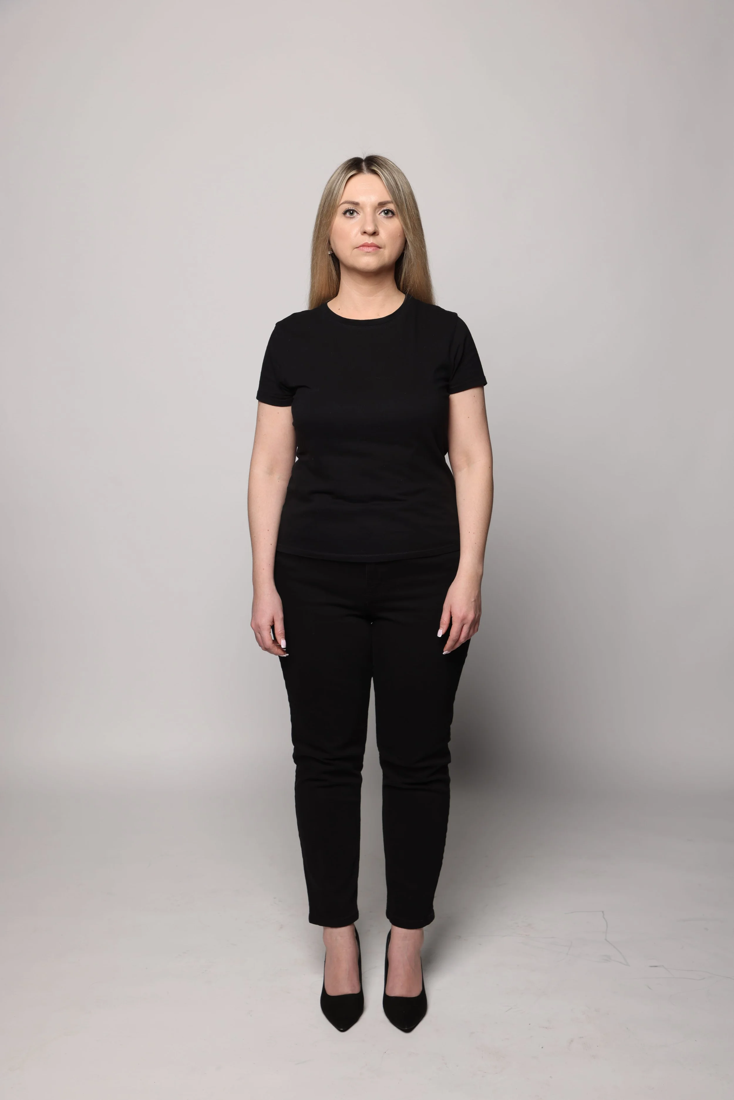 blonde woman black tshirt black jean smiling3.jpg