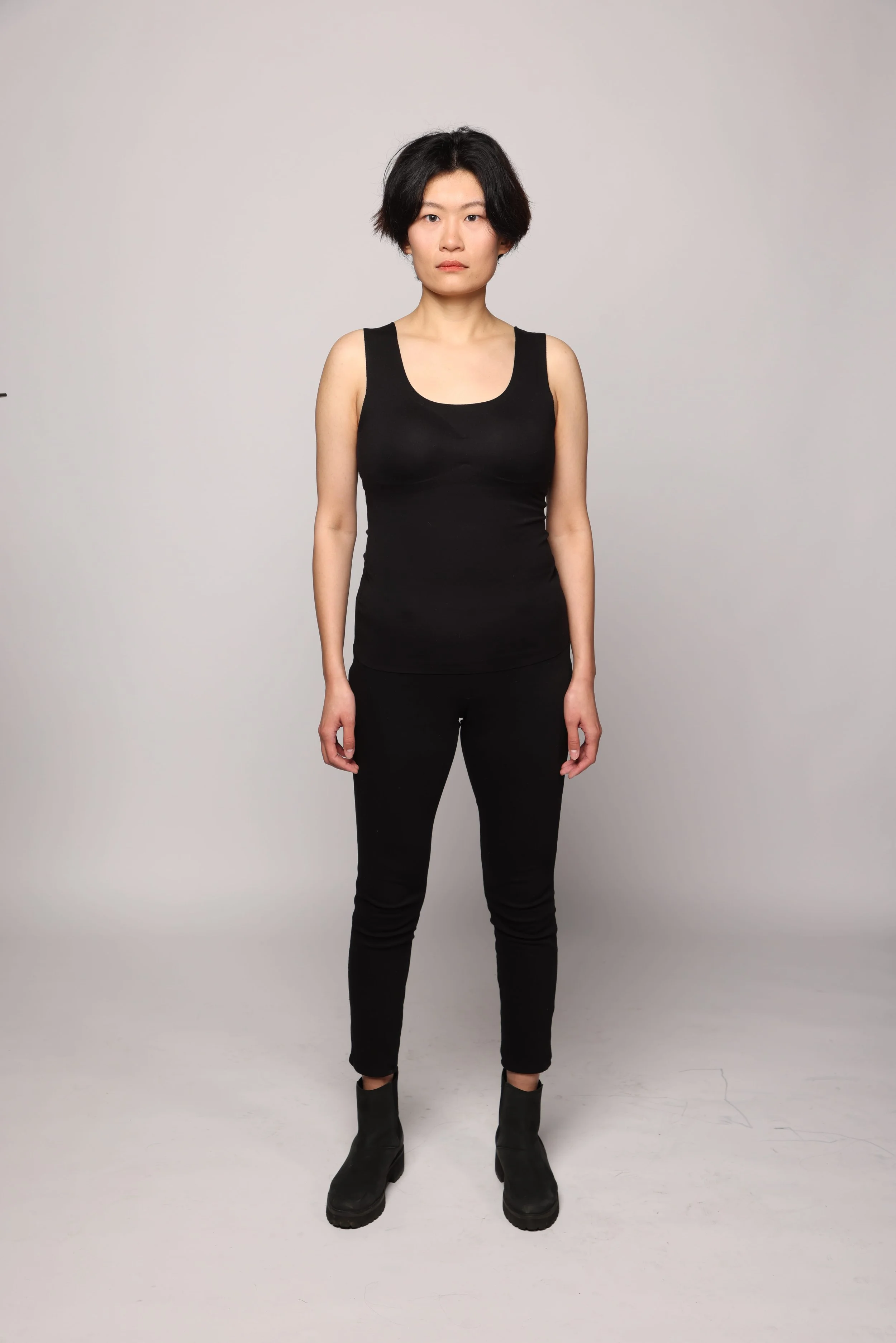 short hair woman black tshirt black pant smiling1.jpg