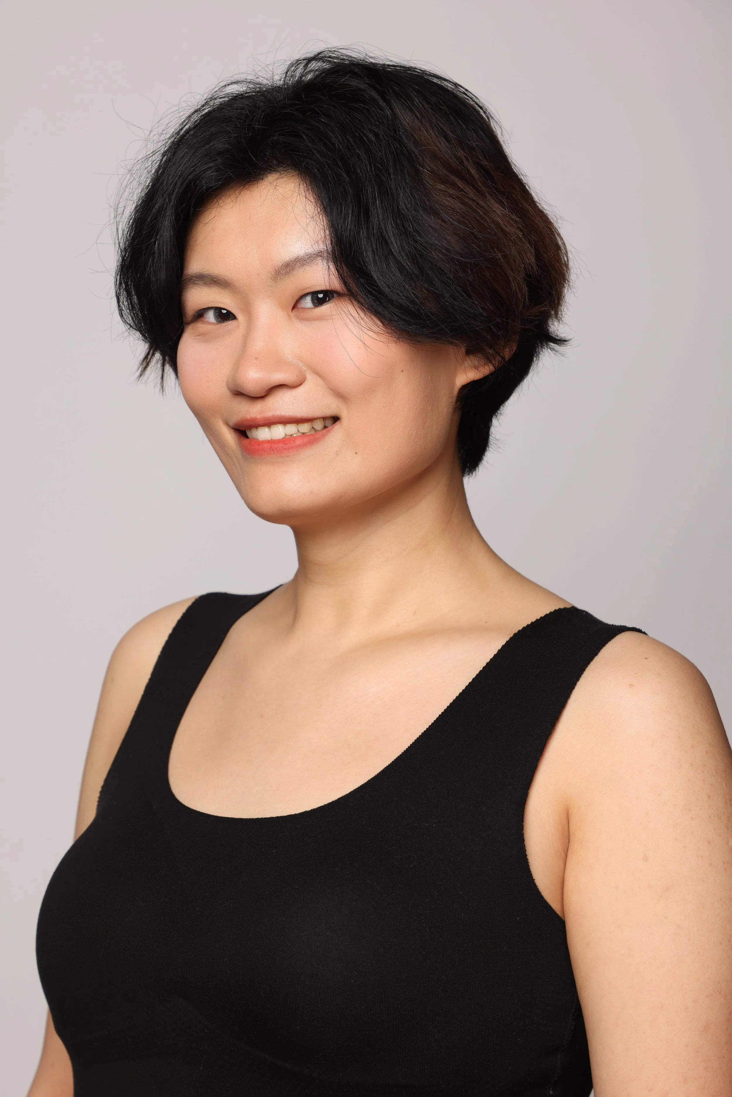 short hair woman black tshirt black pant smiling4.jpg