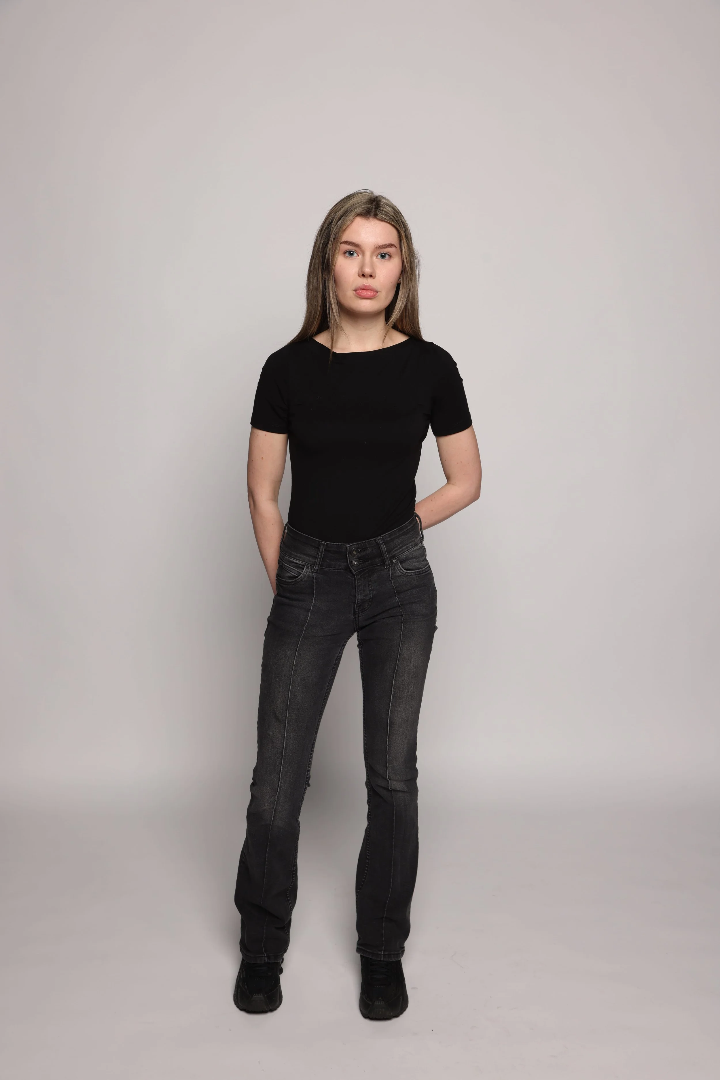 woman black tshirt black jean smiling1.jpg