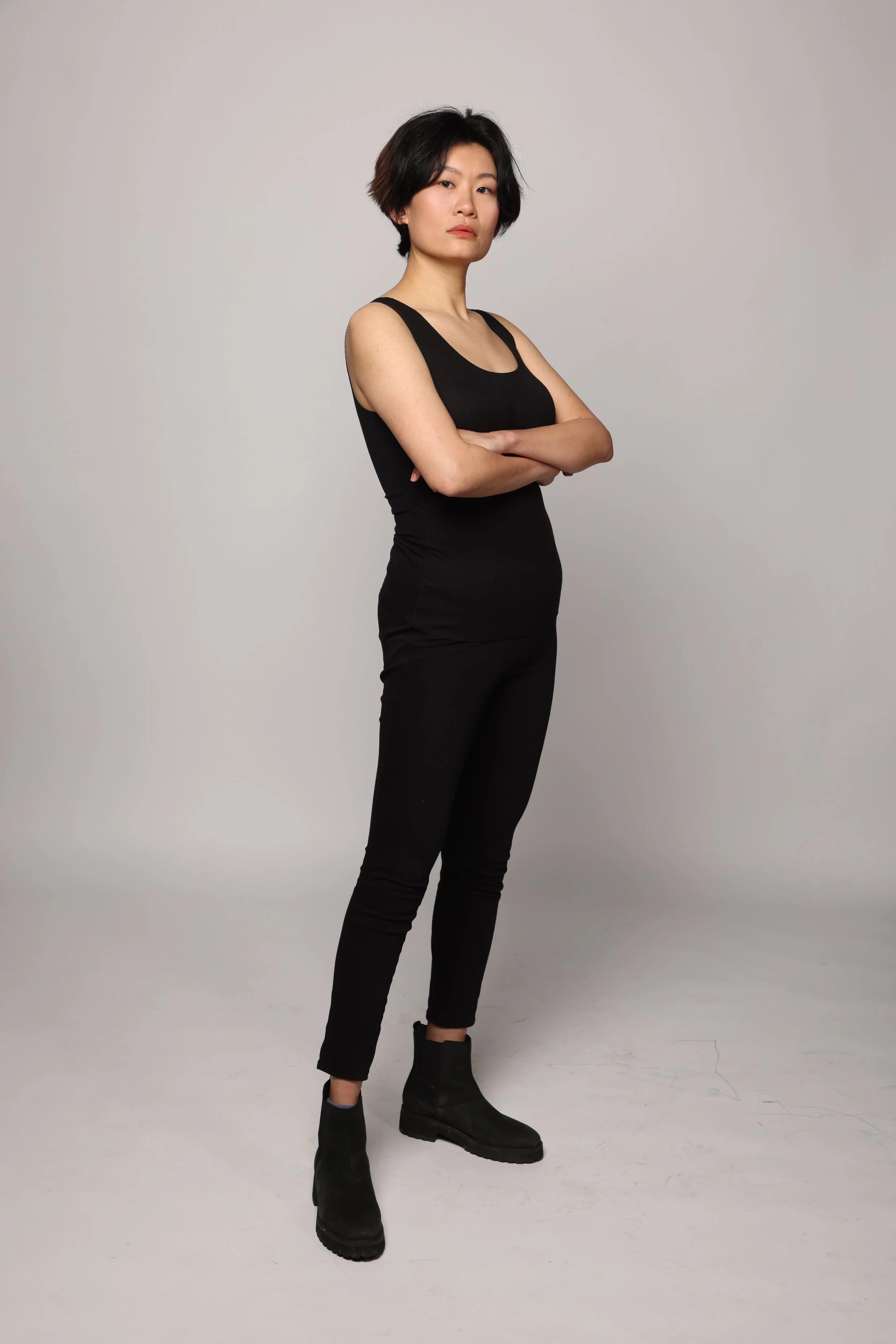 short hair woman black tshirt black pant smiling3.jpg