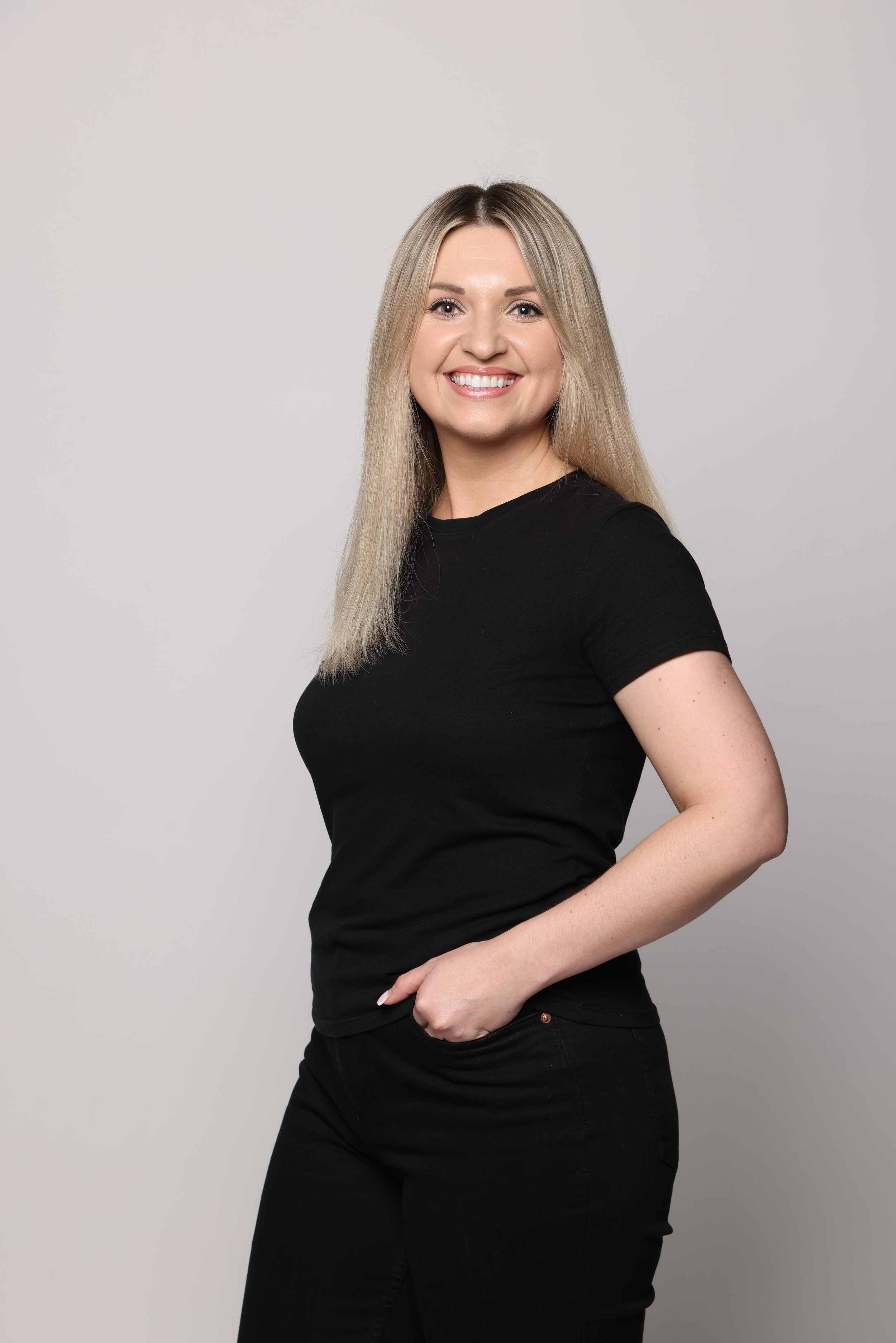 blonde woman black tshirt black jean smiling2.jpg