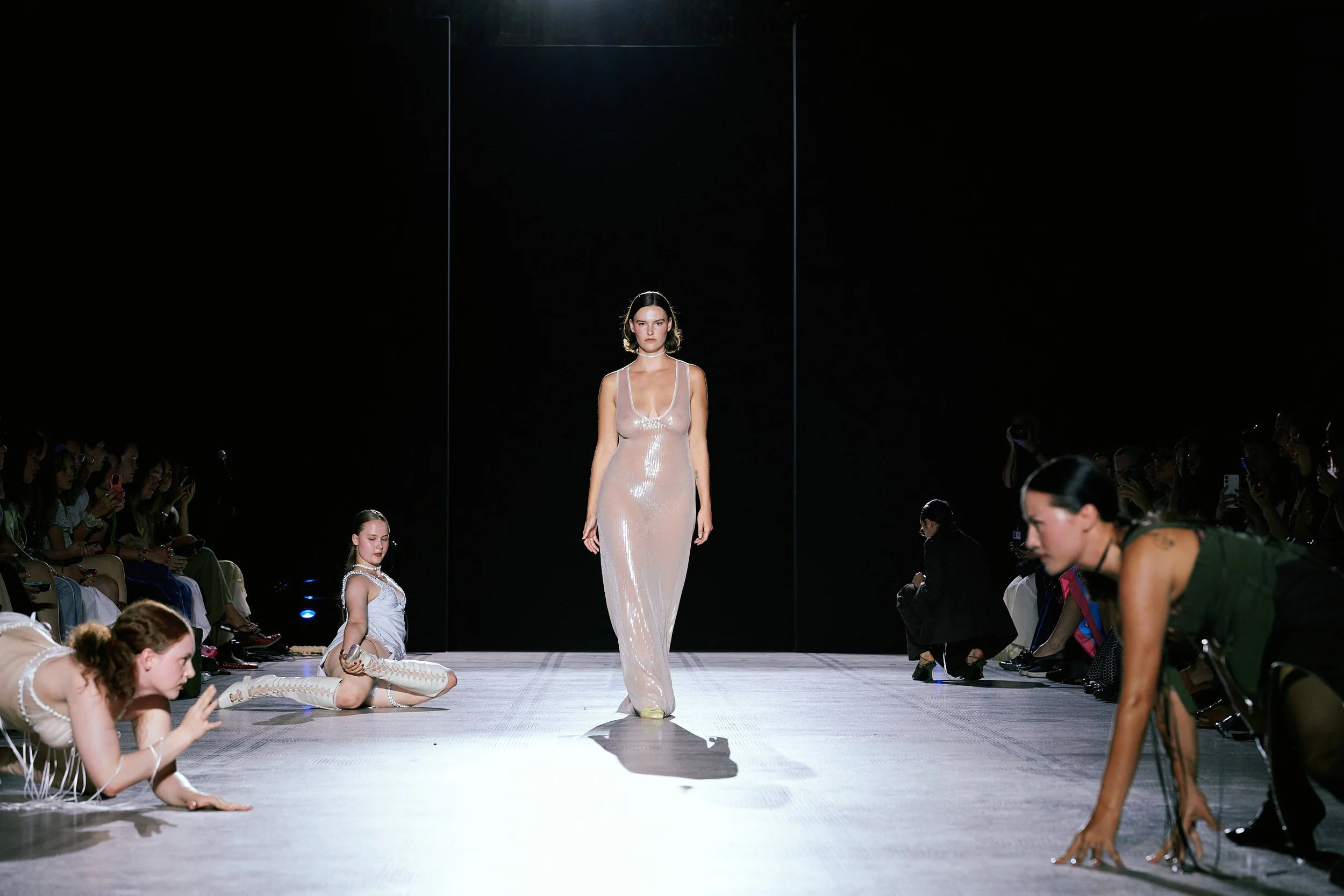 Sinead O'Dwyer showcasing a previous collection at a fashion event. White female model posing on stage wearing Sinéad O’Dwyer