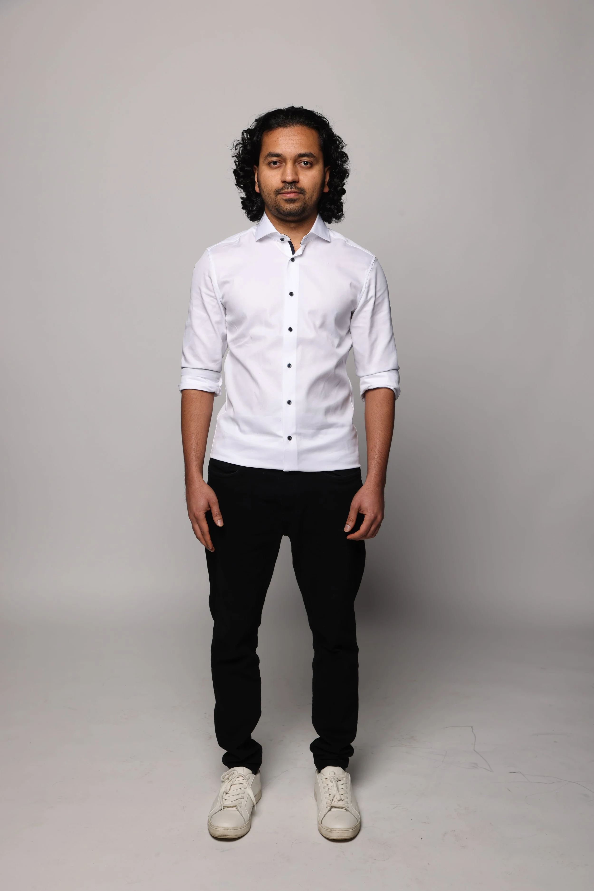 long hair man white tshirt black jean smiling1.jpg