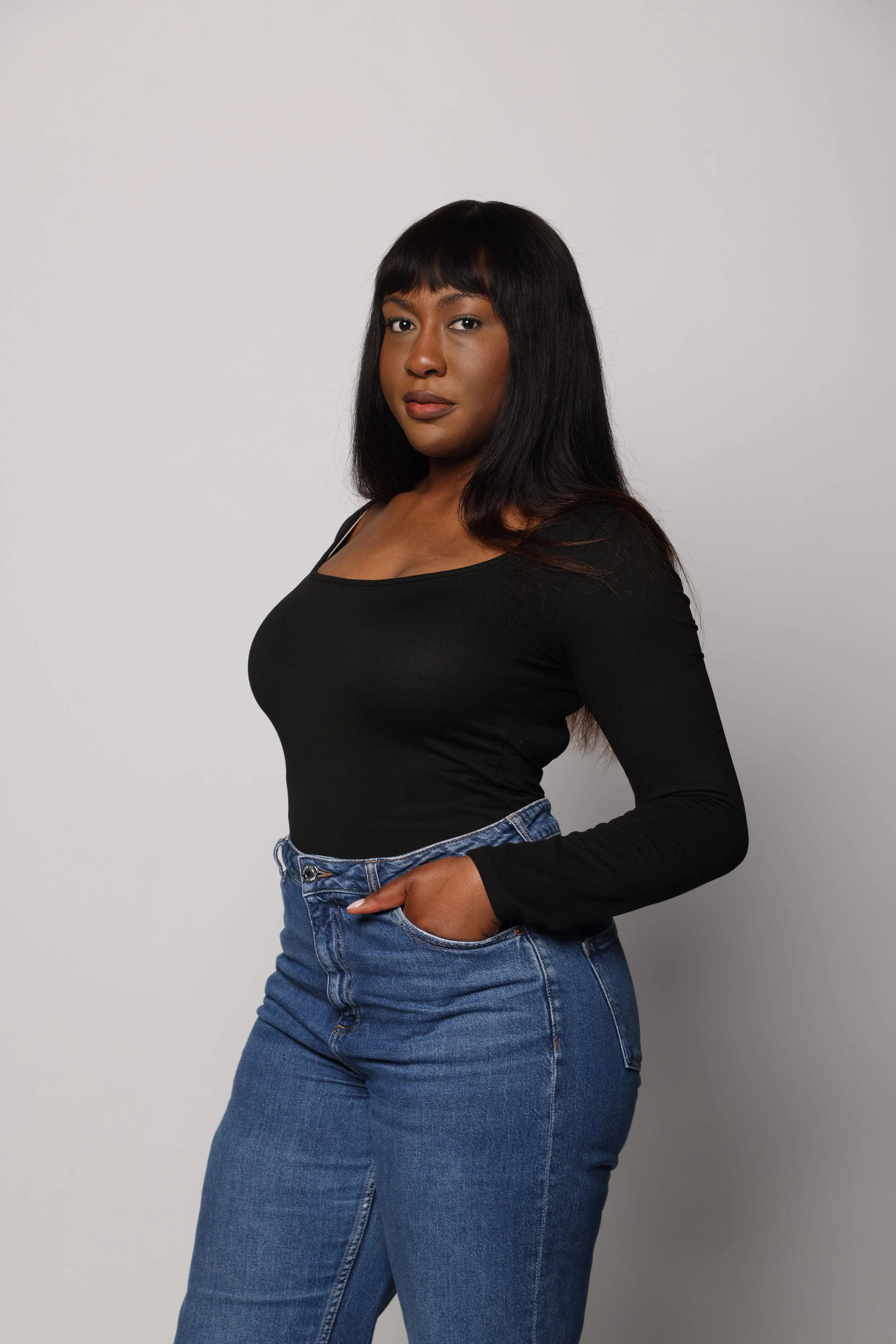 black hair woman black tshirt blue jean smiling3.jpg