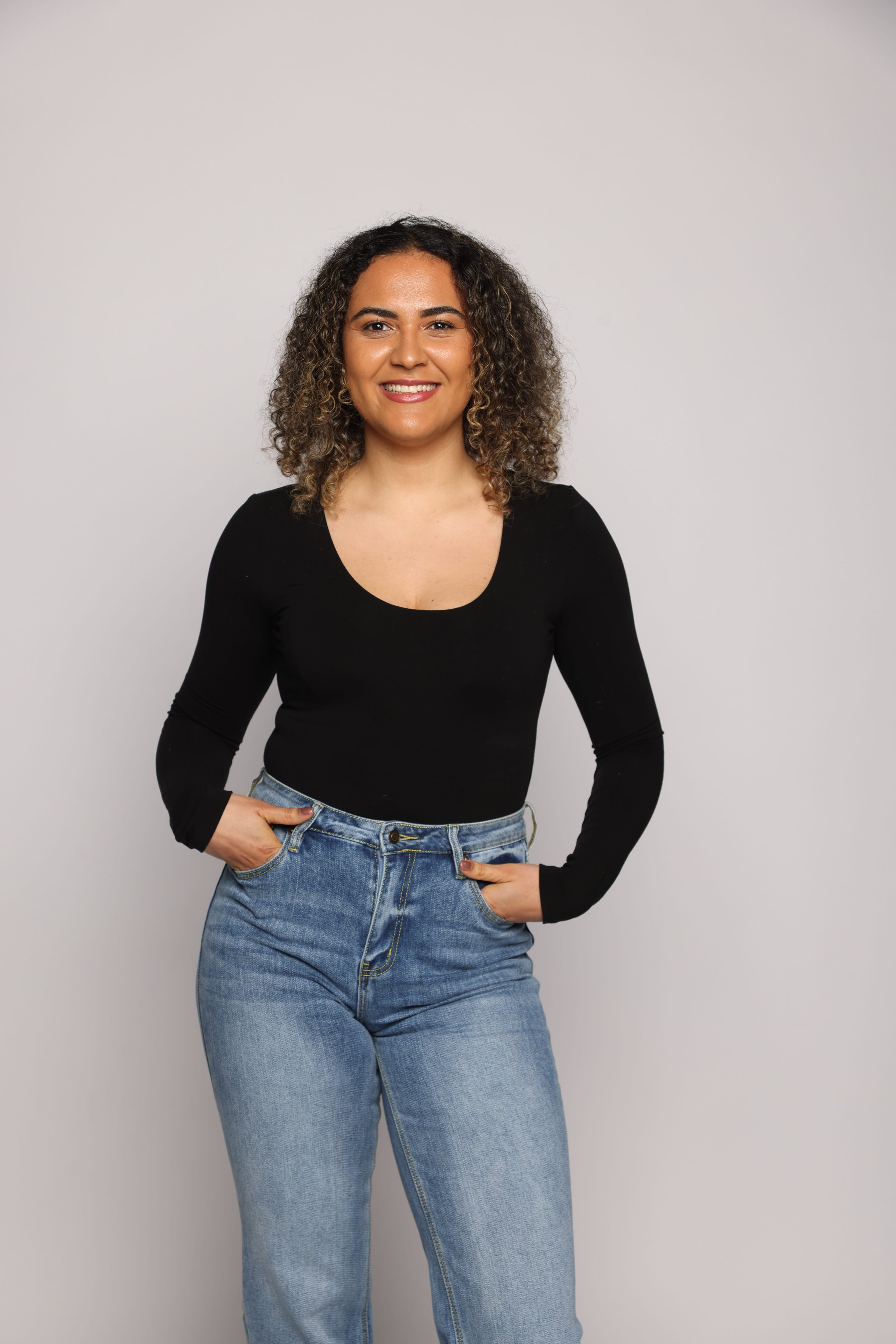 long hair woman black tshirt blue jean smiling3.jpg