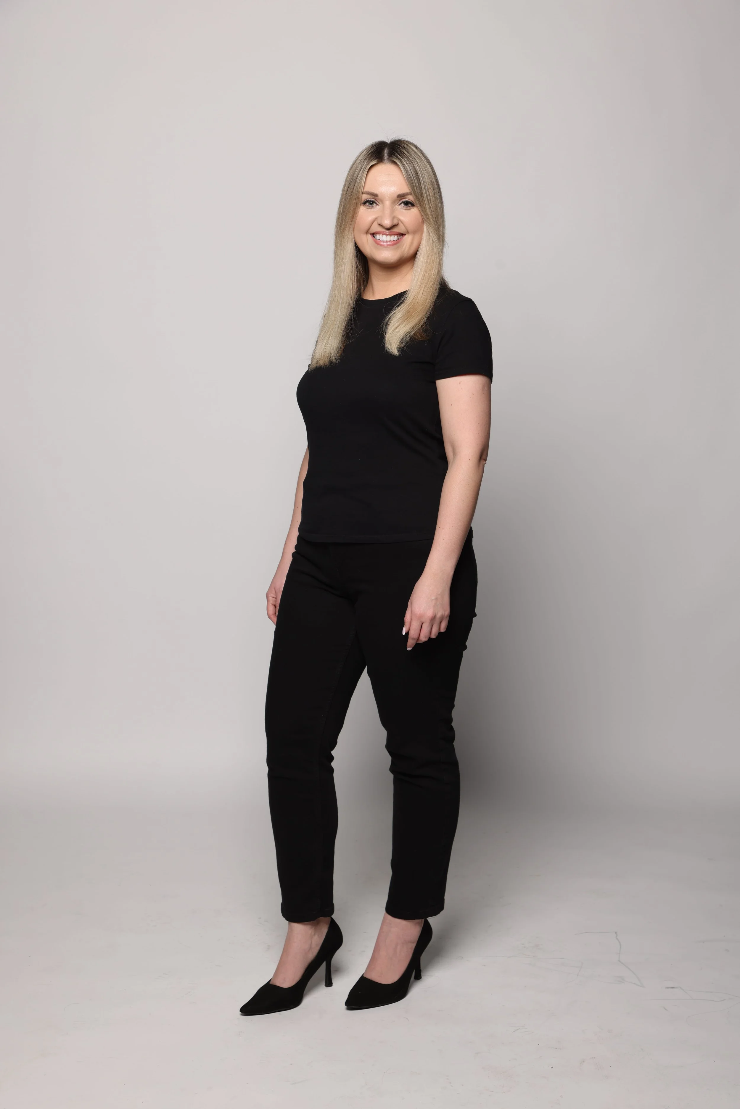 blonde woman black tshirt black jean smiling1.jpg