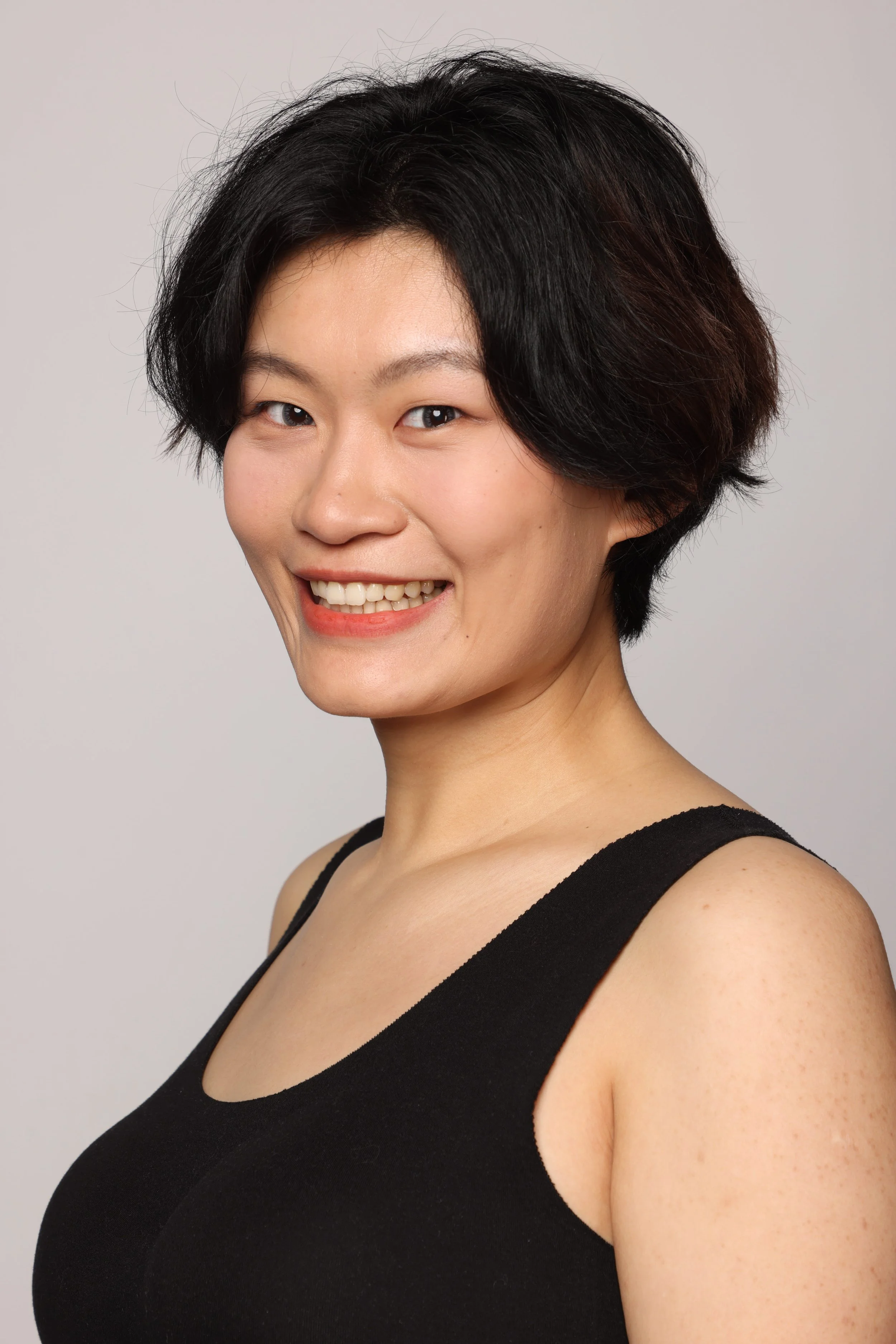 short hair woman black tshirt black pant smiling6.jpg