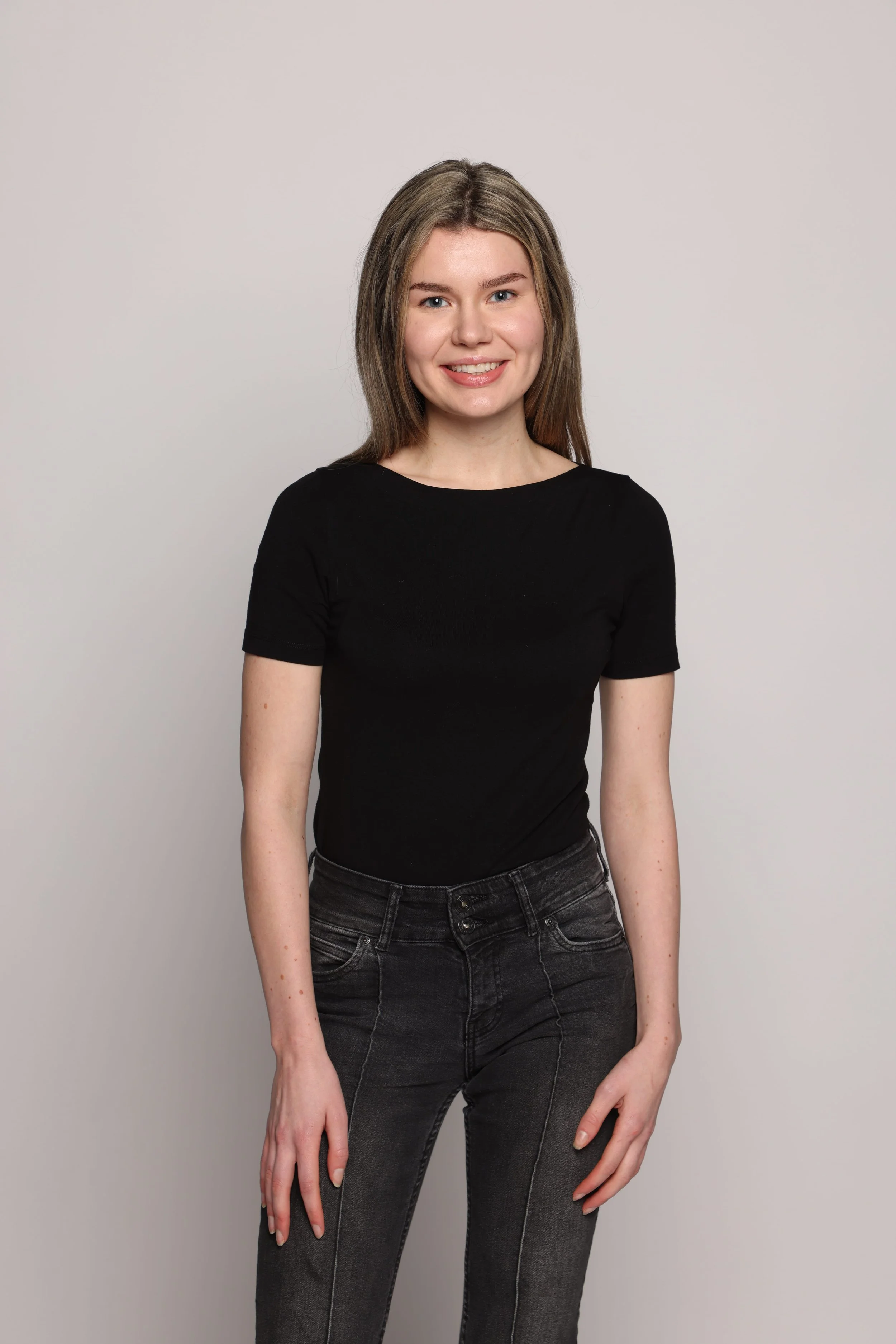 woman black tshirt black jean smiling3.jpg