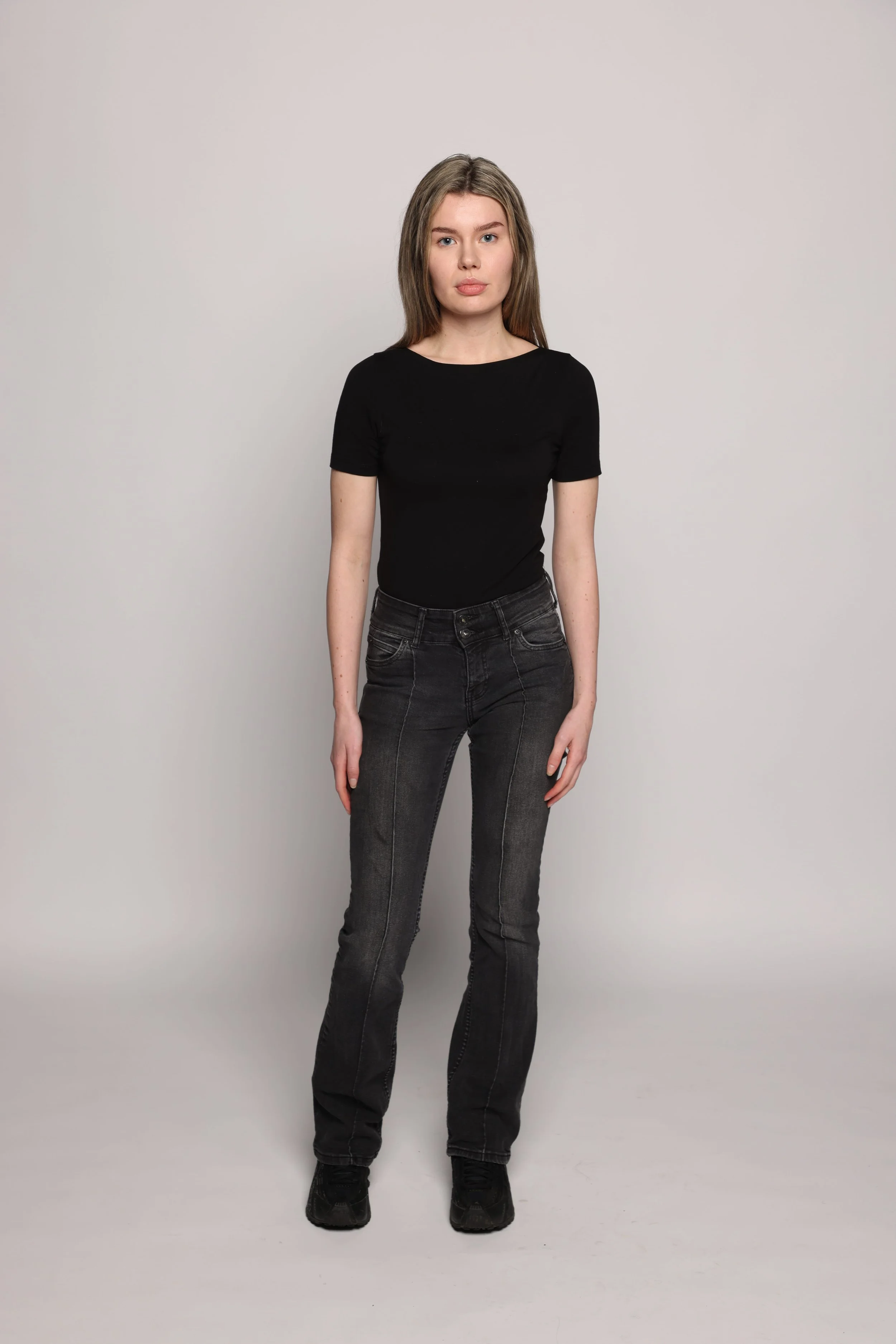 woman black tshirt black jean smiling2.jpg