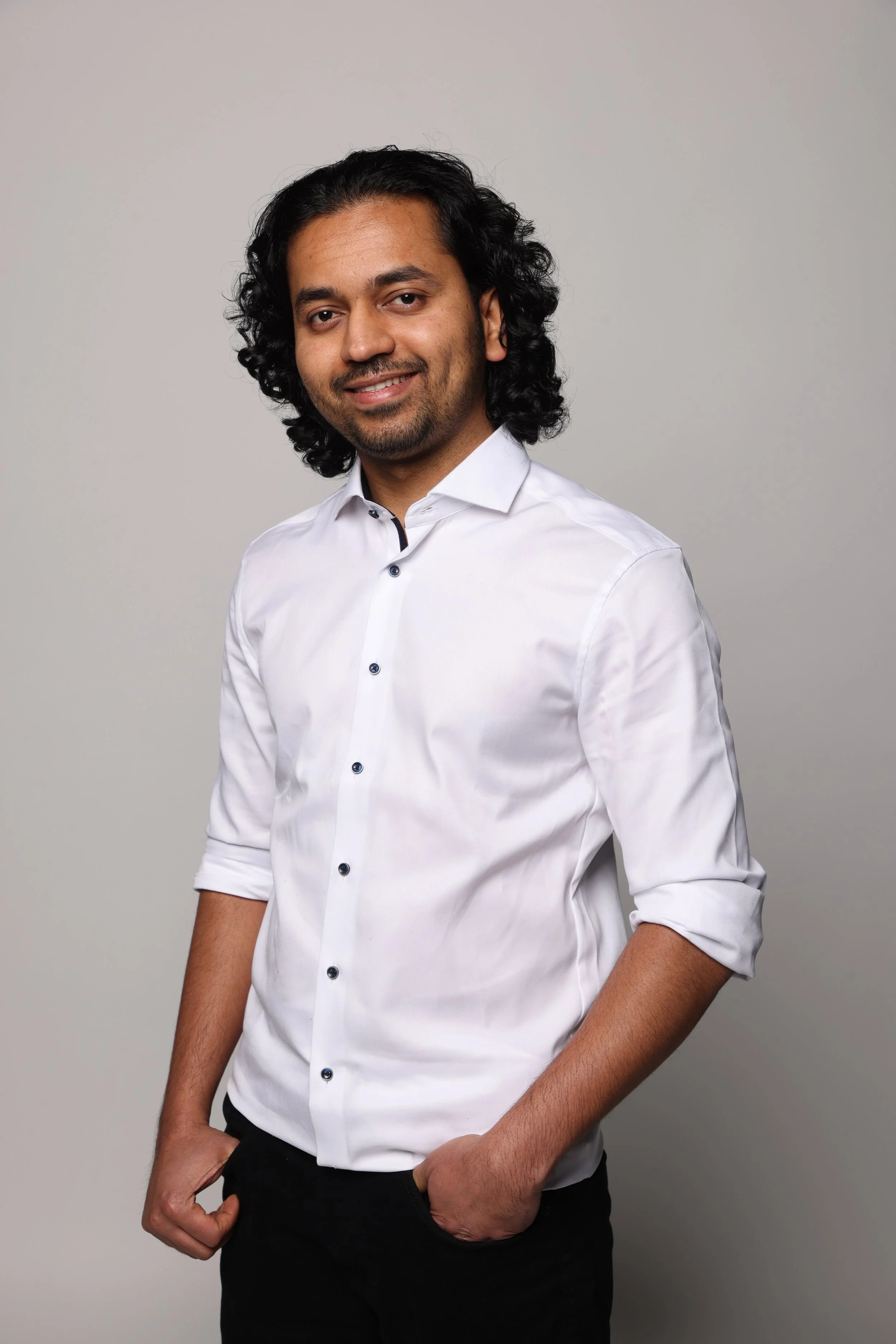 long hair man white tshirt black jean smiling4.jpg