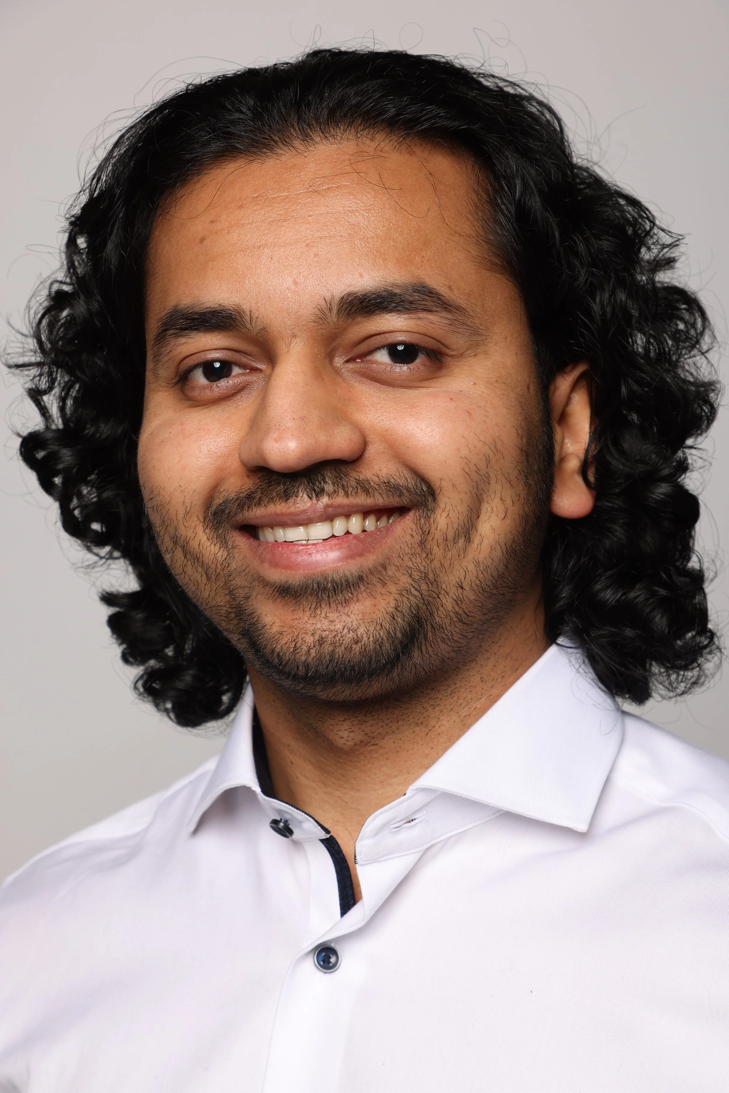 long hair man white tshirt black jean smiling3.jpg