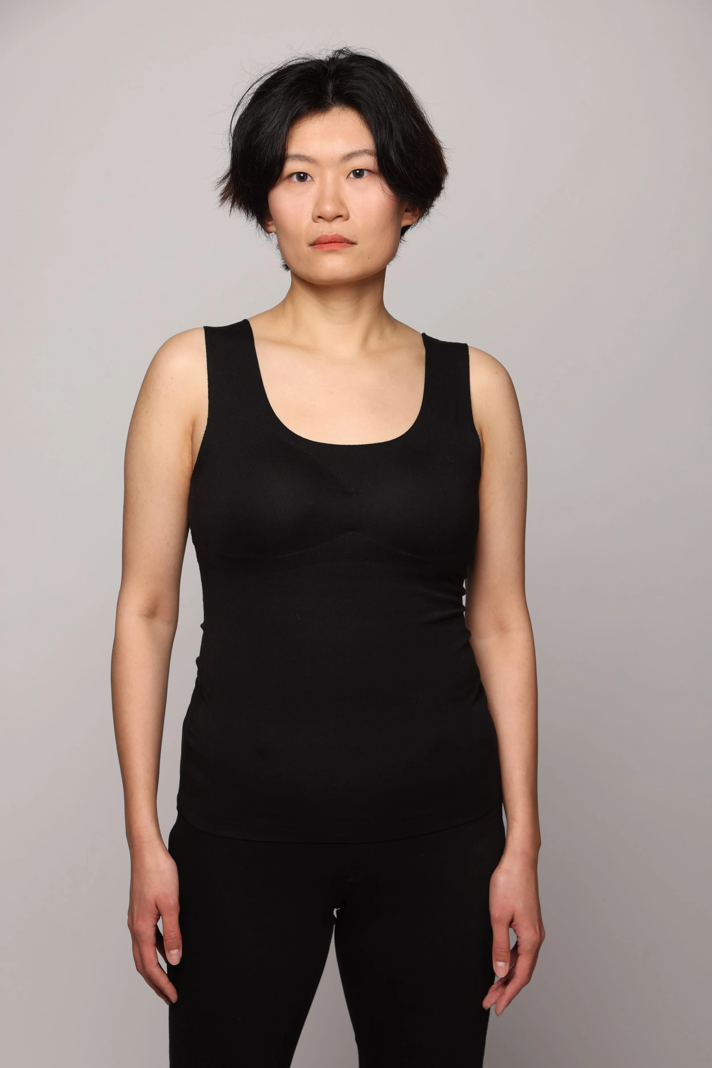 short hair woman black tshirt black pant smiling2.jpg