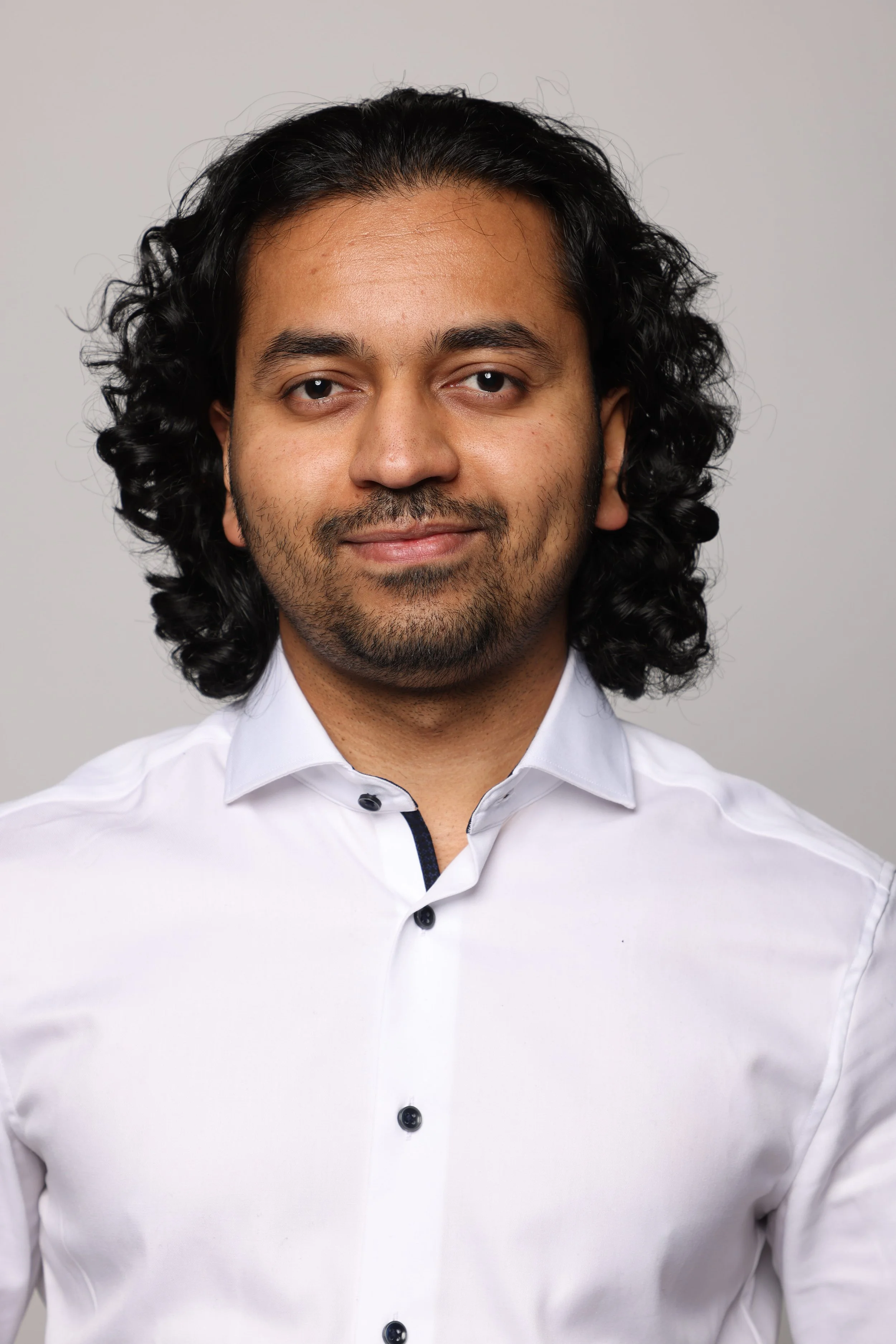 long hair man white tshirt black jean smiling2.jpg