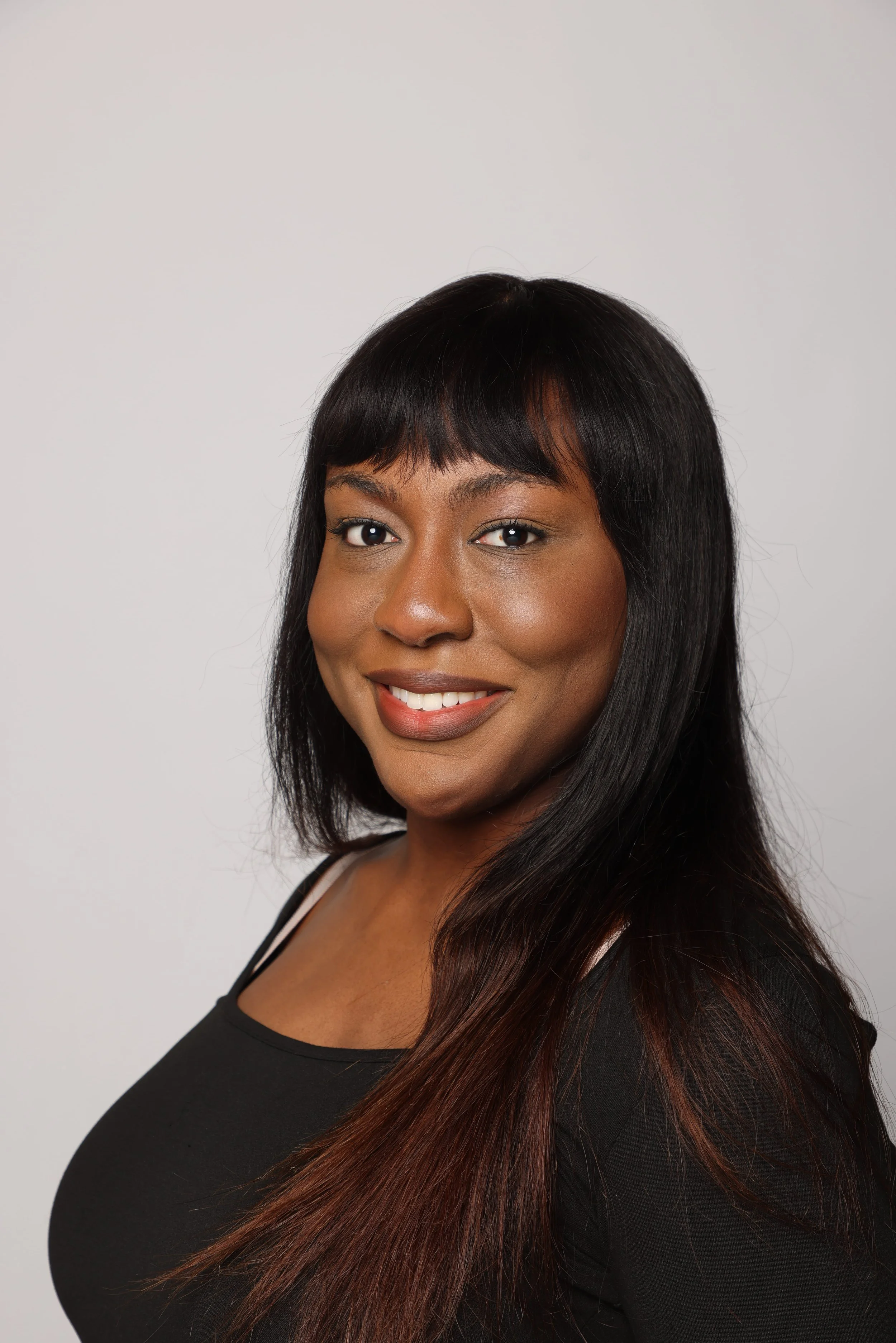 black hair woman black tshirt blue jean smiling5.jpg