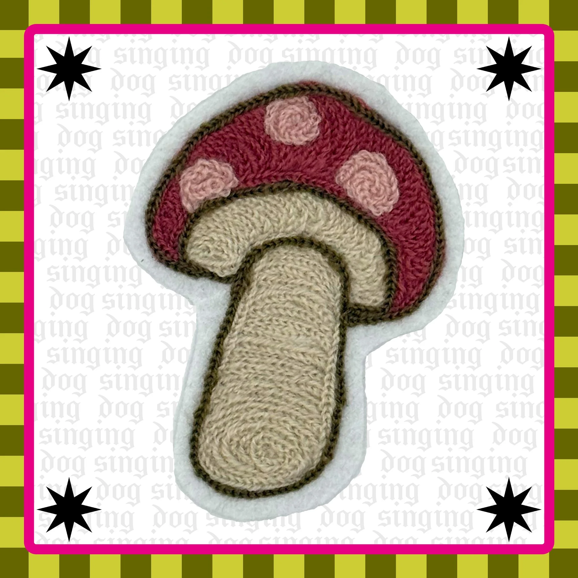 A embroidered pink and maroon fairytale mushroom with a beige stem. The outlines are stitched with brown thread.  