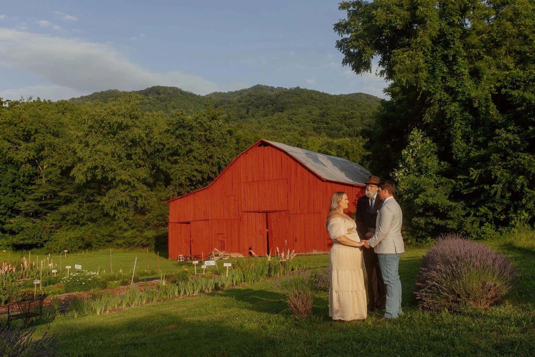 A couple marries in front of a big red barn with Buffalo Mountain Views in the Background