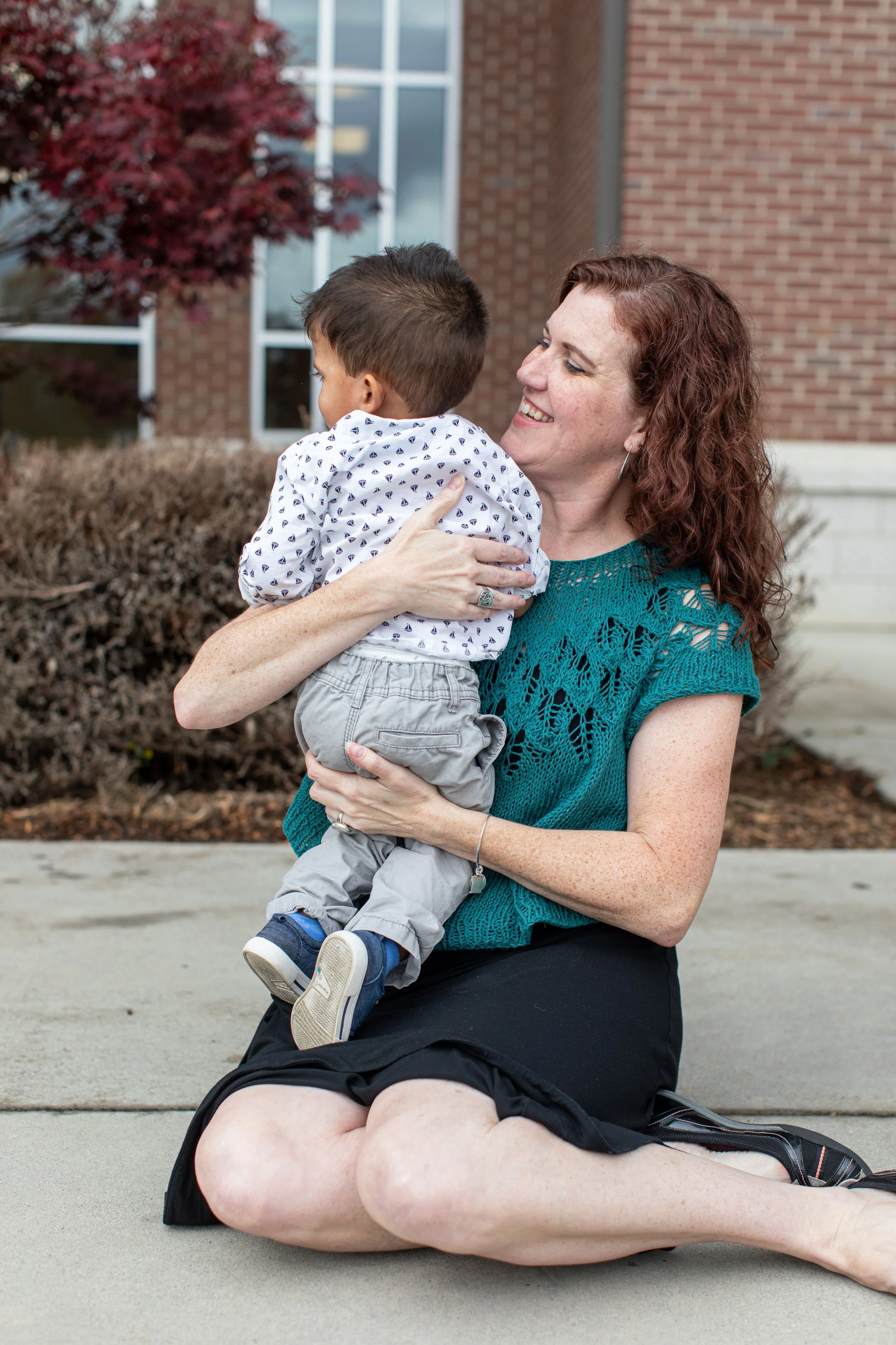 A woman holds a small child
