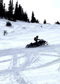 One snowmobile and rider in Colorado during a Movement and technical skills course